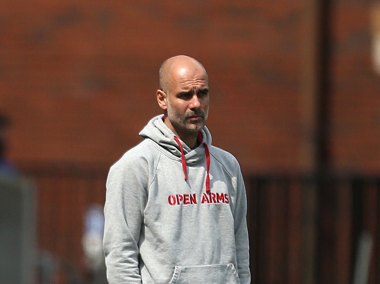 Manchester City coach Pep Guardiola wearing an Open Arms hoodie