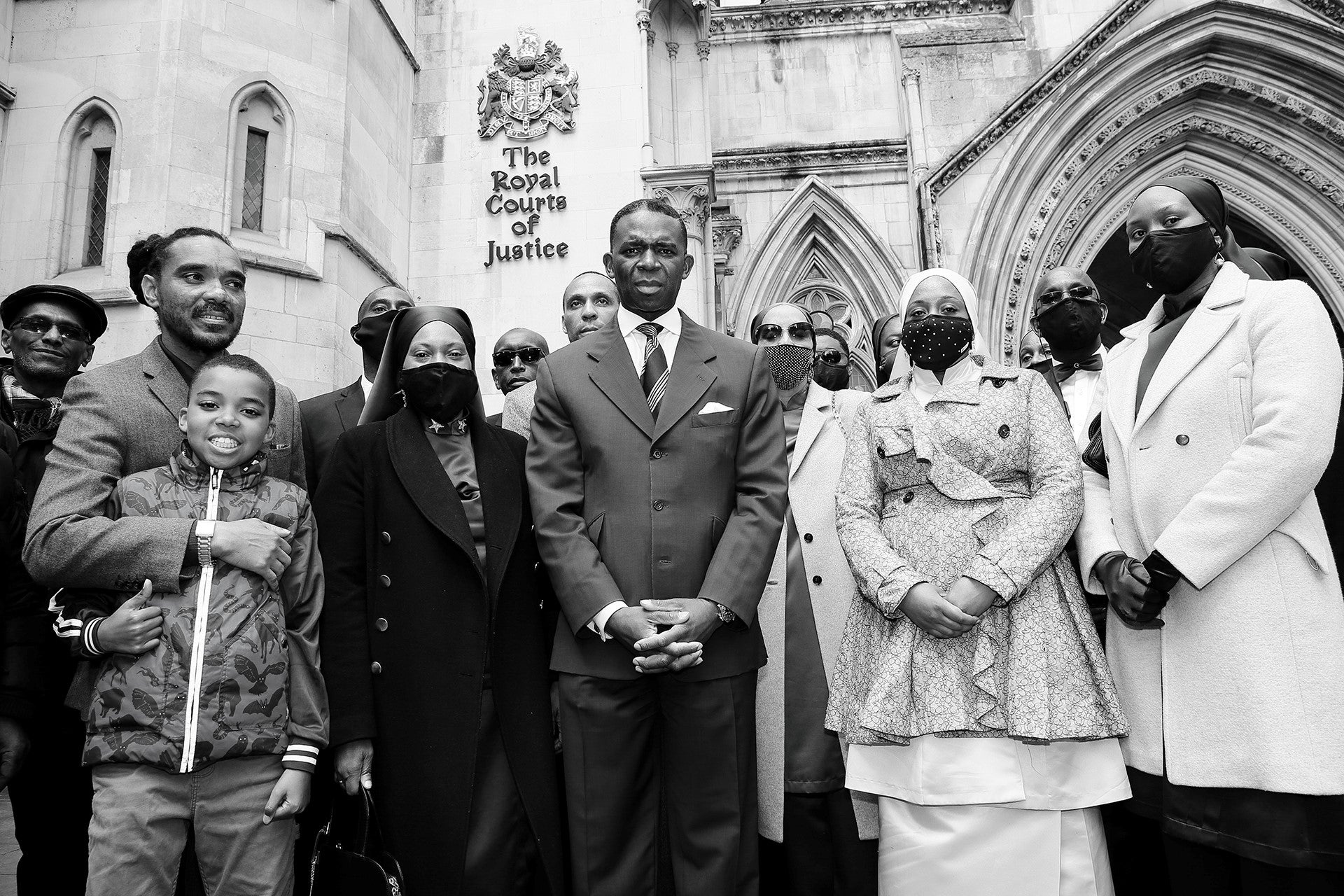 The claimants stand outside the High Court following their victory