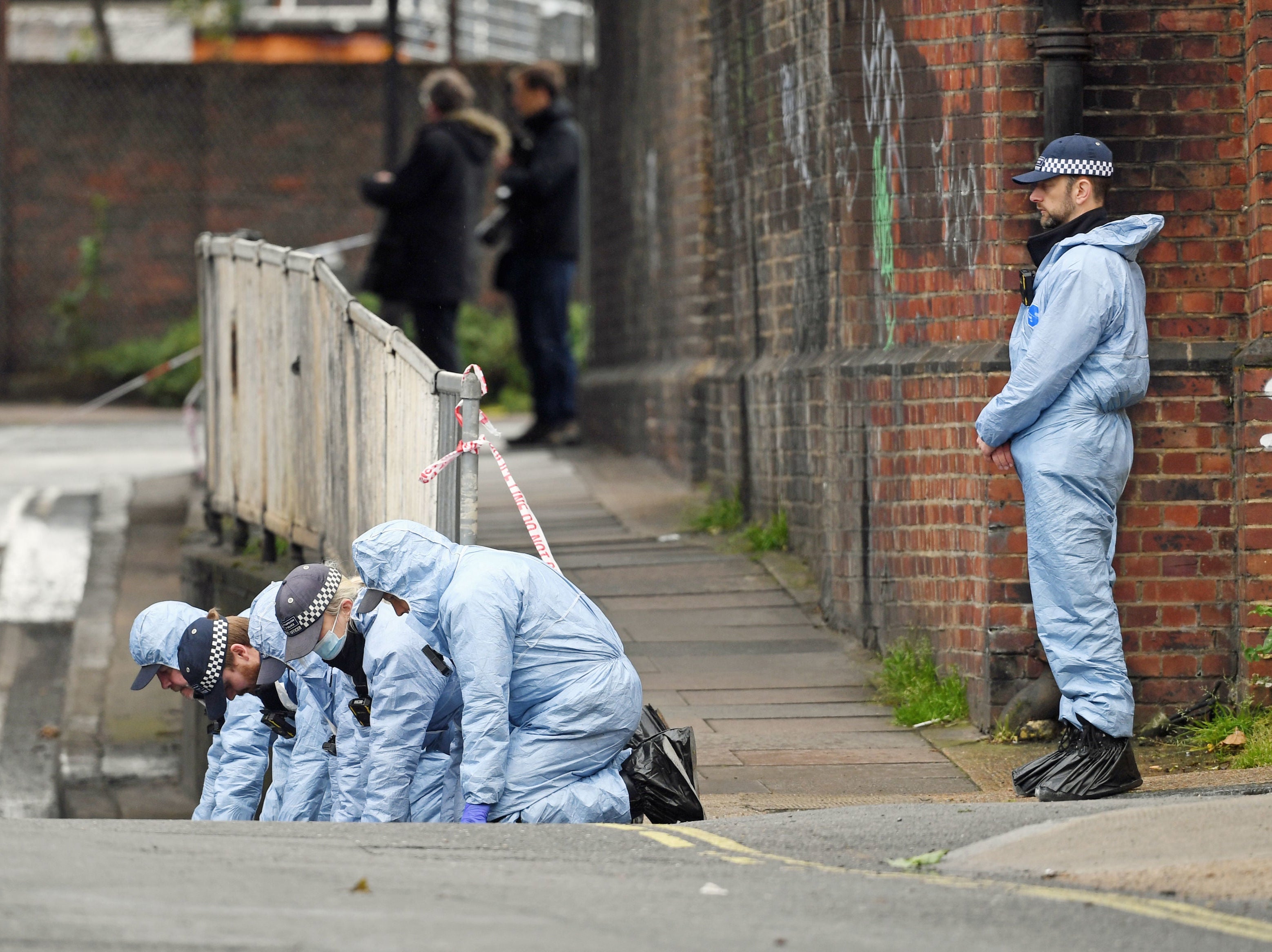 Police forensic officers search a street in Peckham, southeast London, close to where activist Sasha Johnson was shot during a party