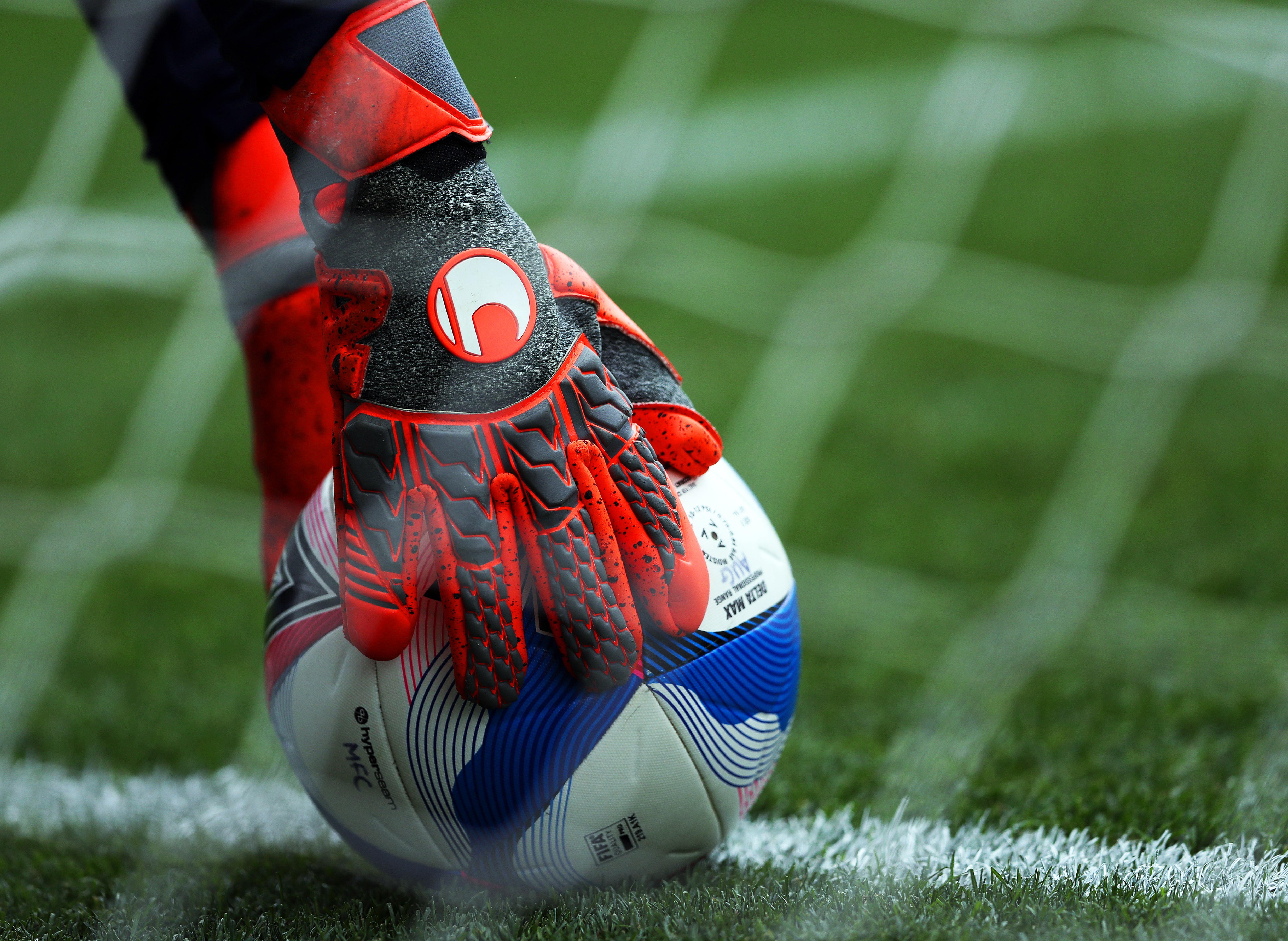 A general view of a goalkeeper picking up the ball