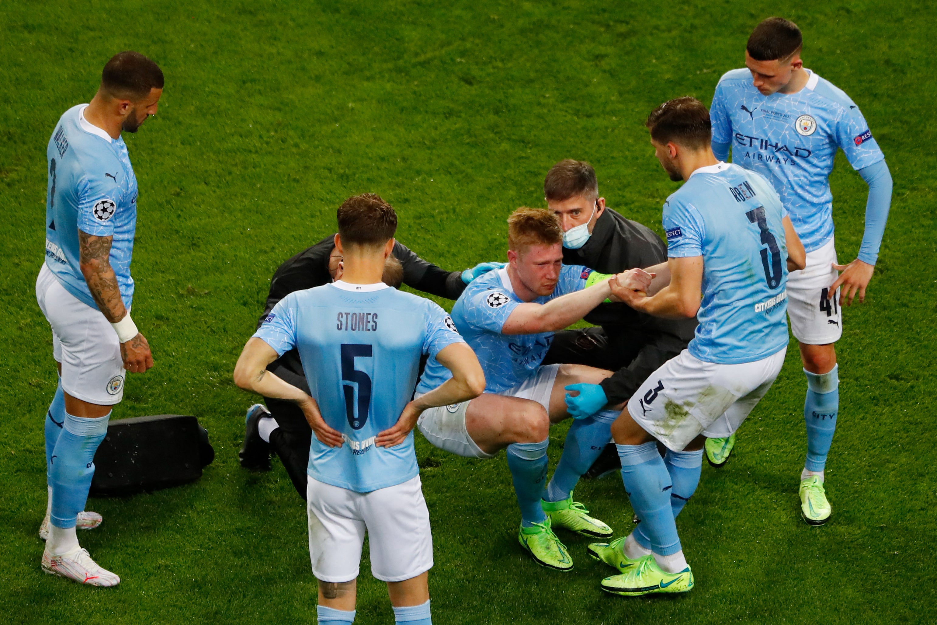 Kevin De Bruyne is helped onto his feet after his injury