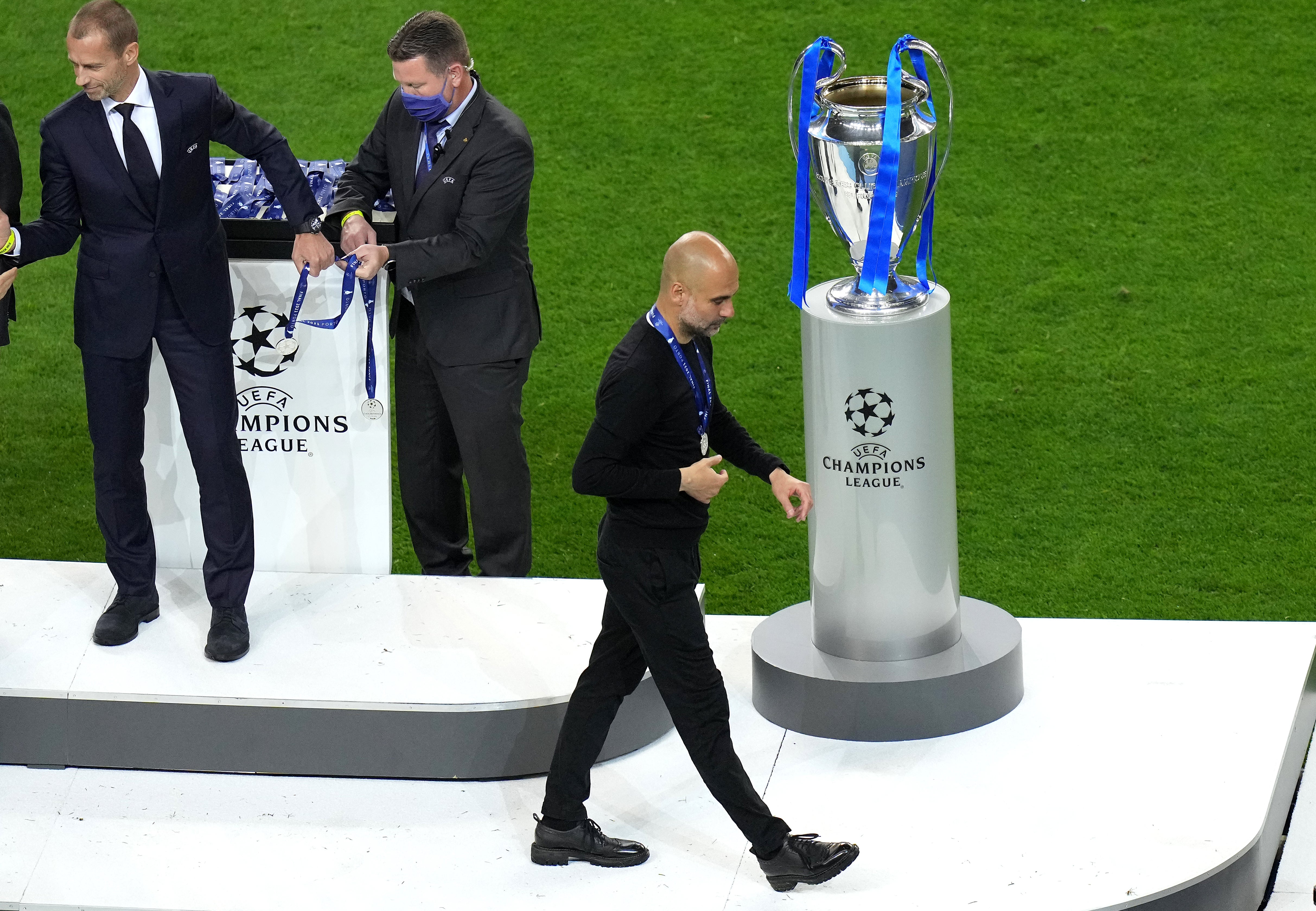 Manchester City boss Pep Guardiola walks past the European Cup after his side were beaten 1-0 by Chelsea in Porto (Adam Davy/PA).