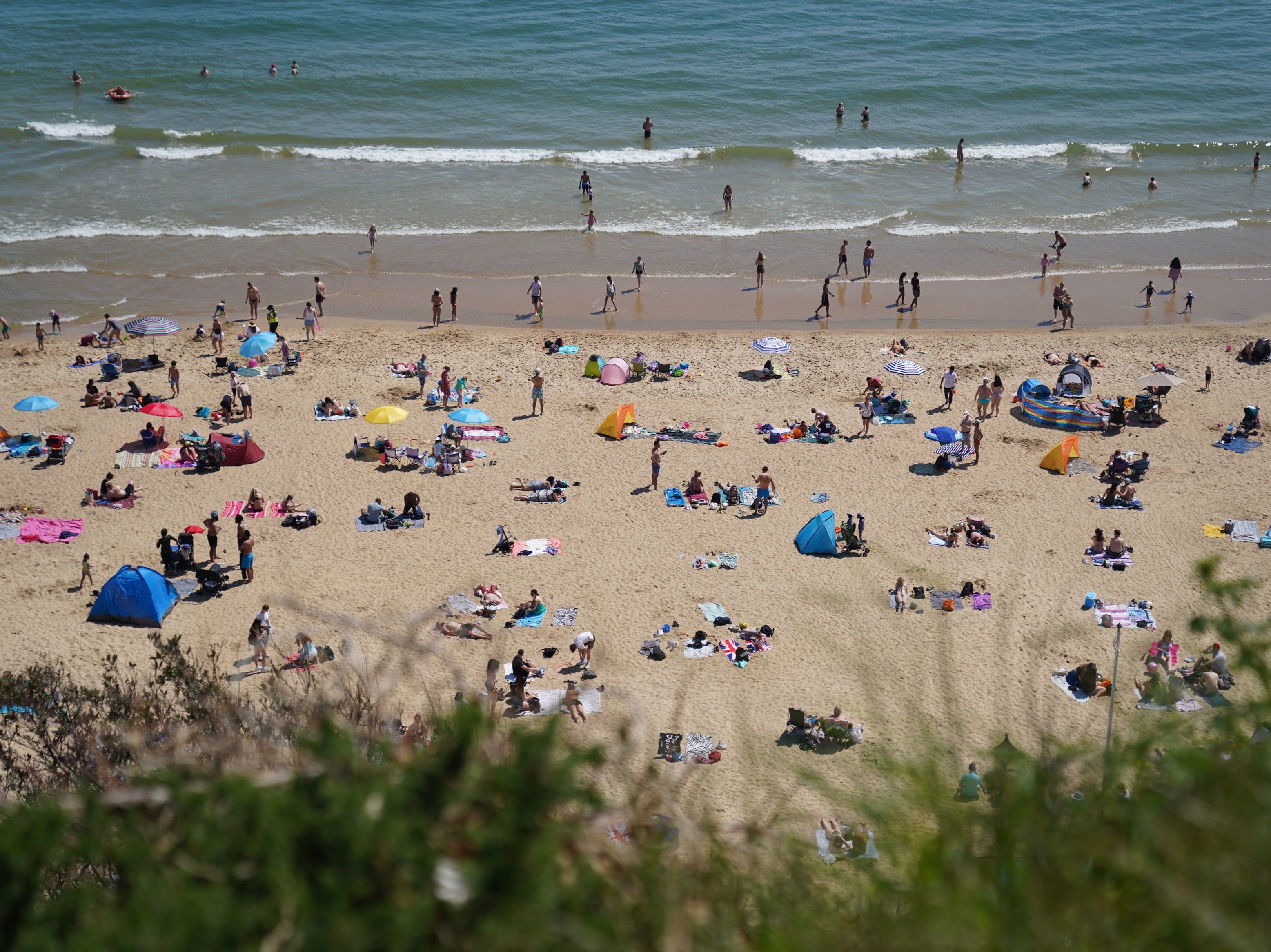 People enjoy the hot weather on Bournemouth beach, Dorset