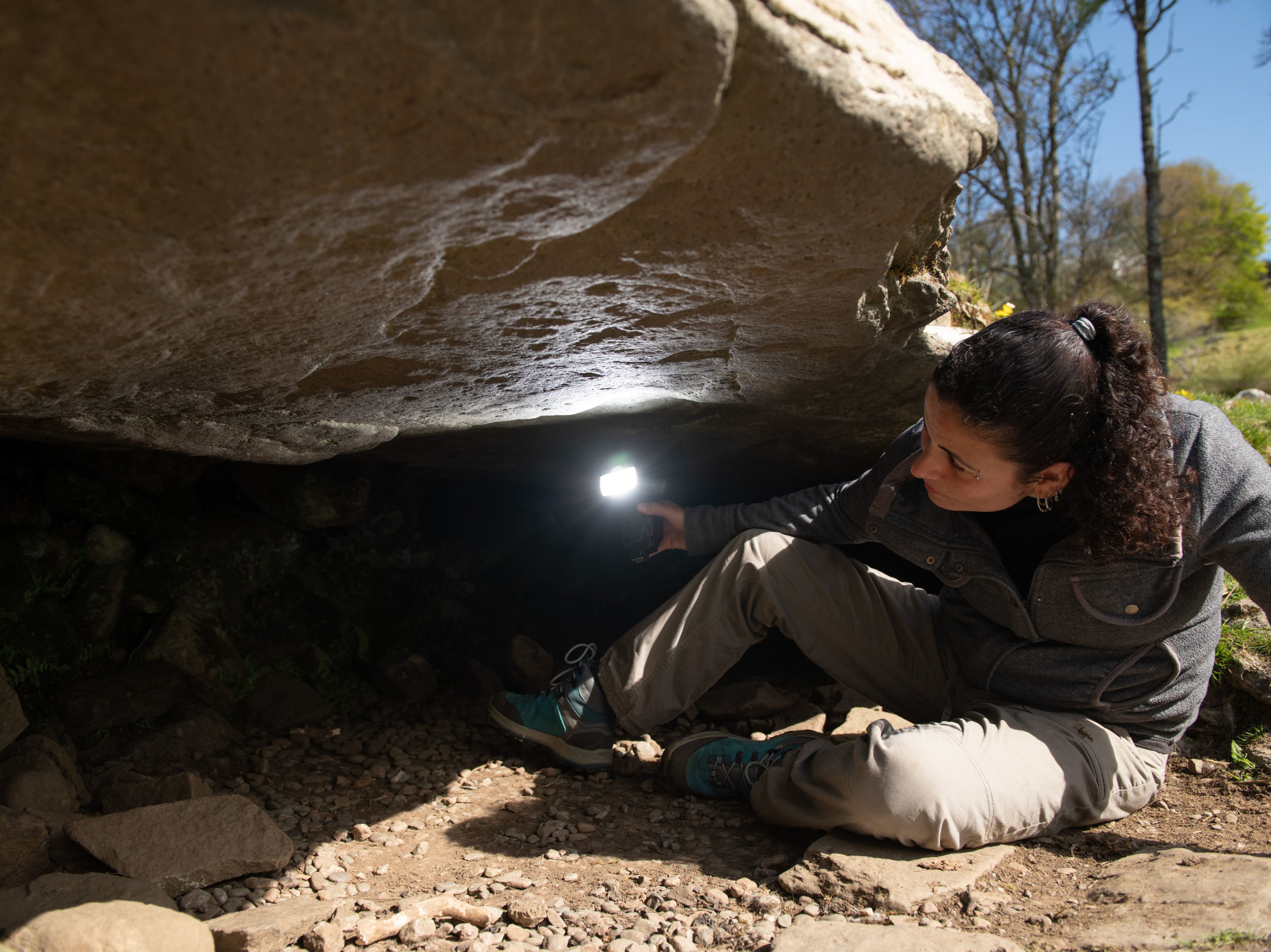 Joana Valdez-Tullett, post-doctoral research assistant, examines the prehistoric carvings found at Kilmartin Glen in Argyll, Scotland.