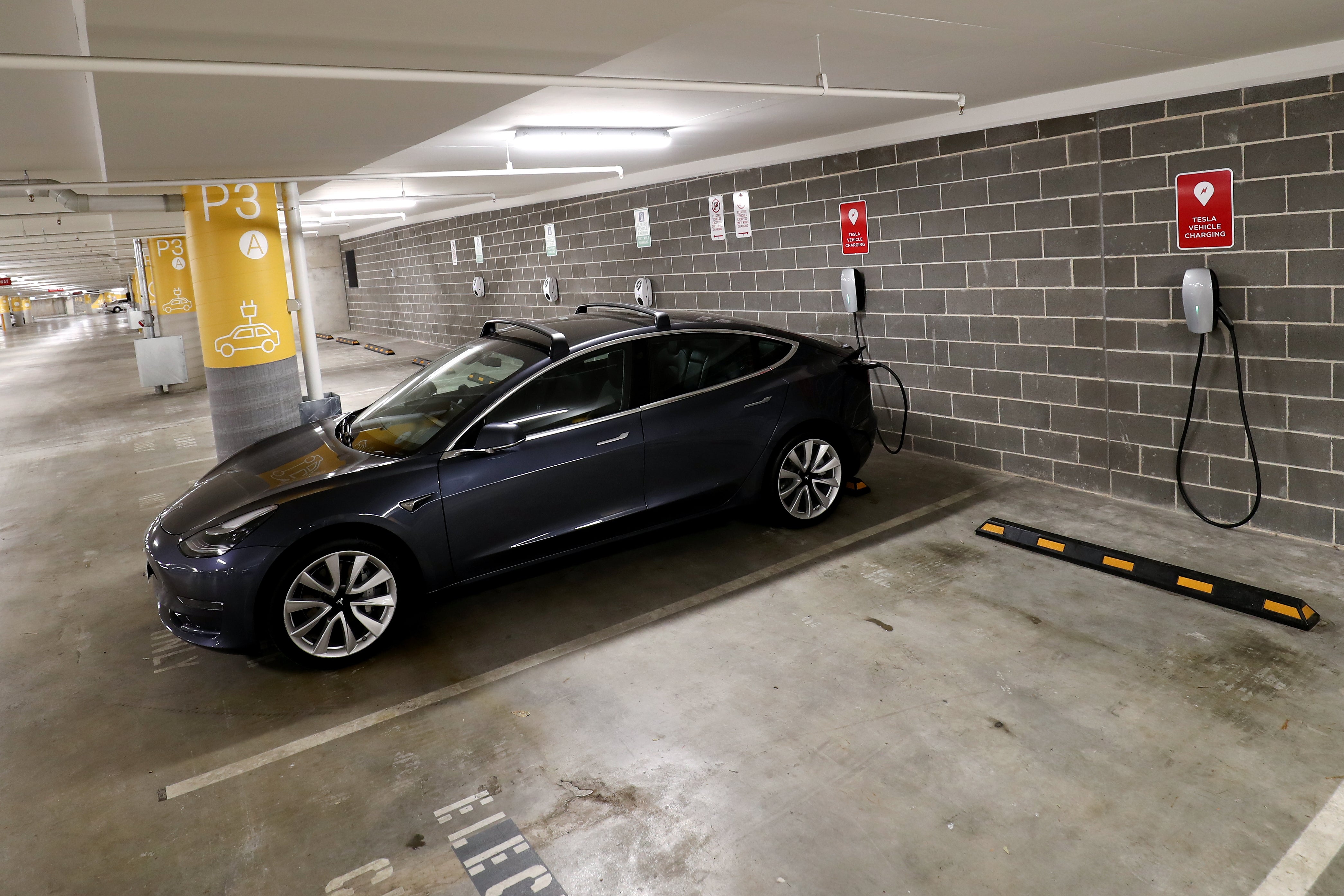 A Tesla Model Y charges at a EV charge station in Lane Cove, Australia