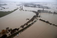 Flood recedes in New Zealand, leaving debris, broken bridge