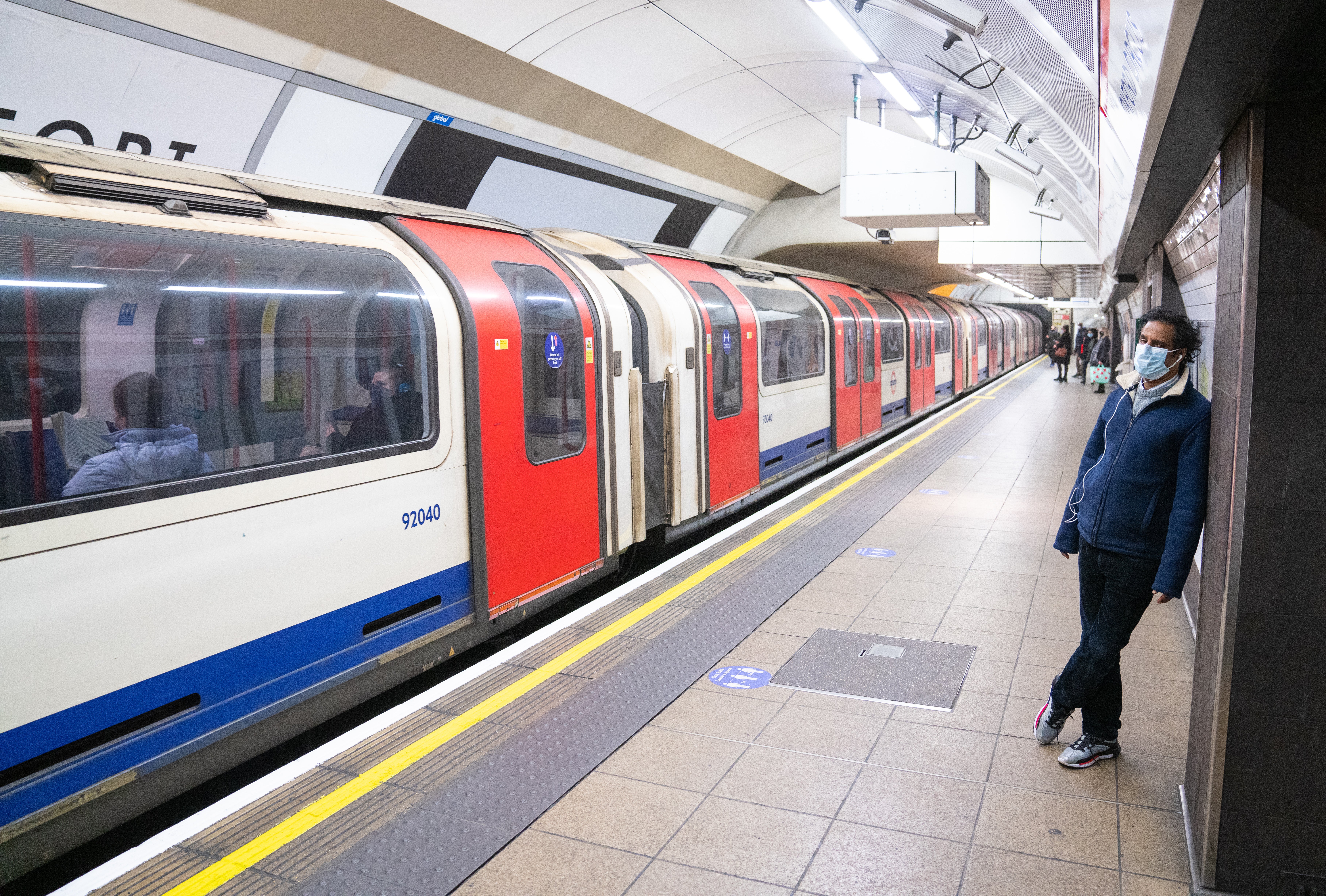 A passenger waits to board a London Underground train