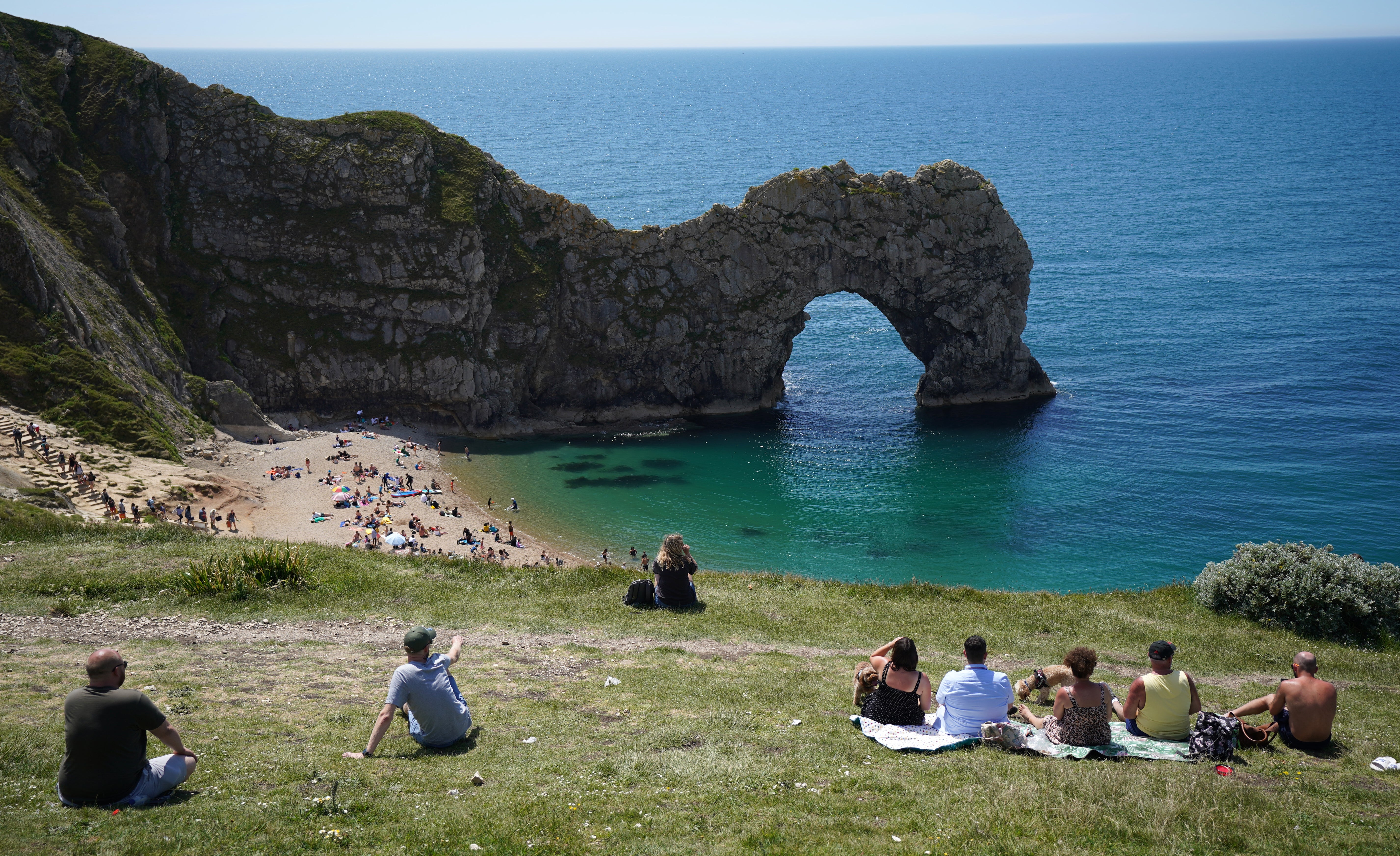 People enjoy the warm weather at Durdle Door