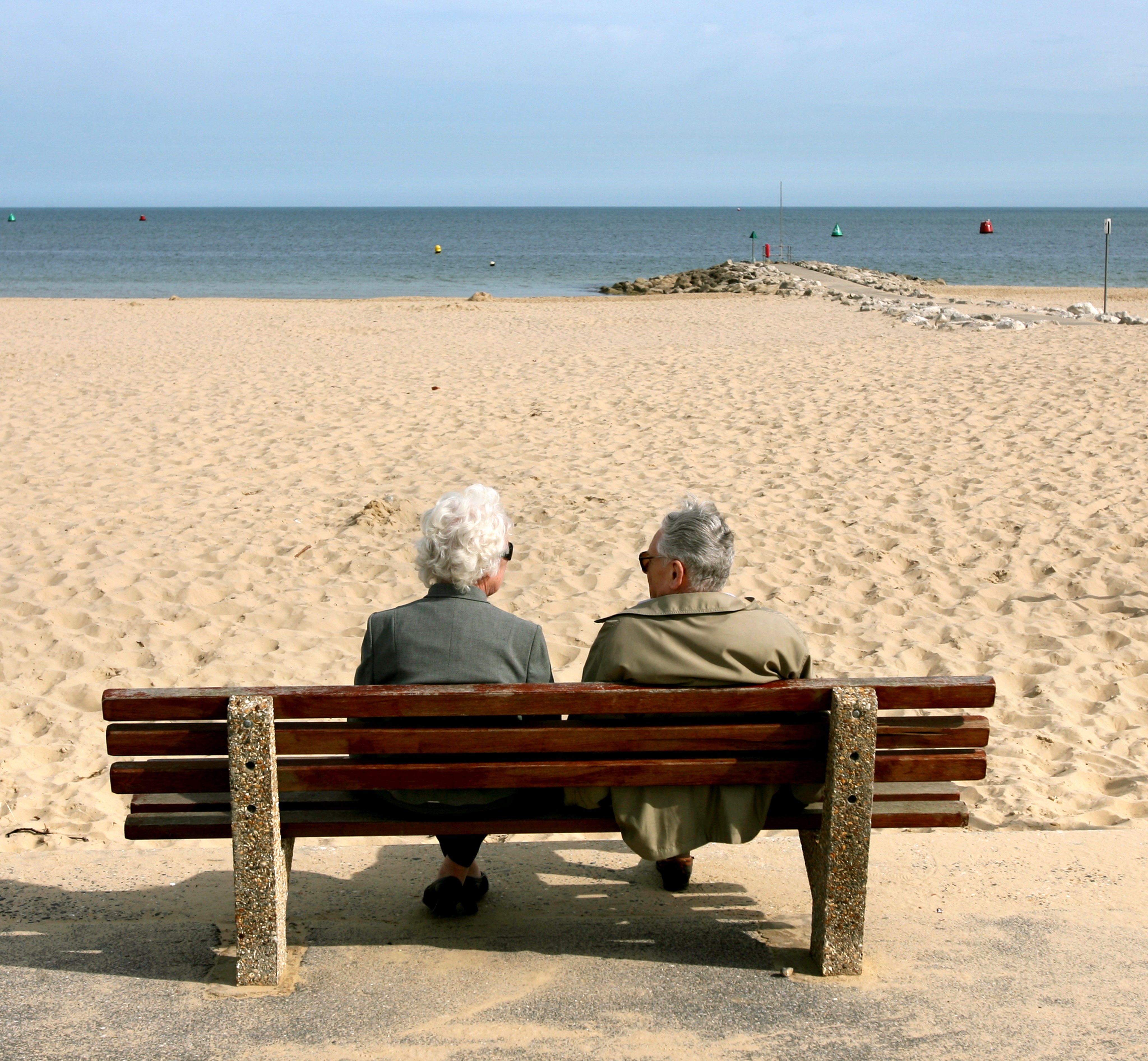 An elderly couple enjoy the sunshine at Sandbanks in Poole, Dorset