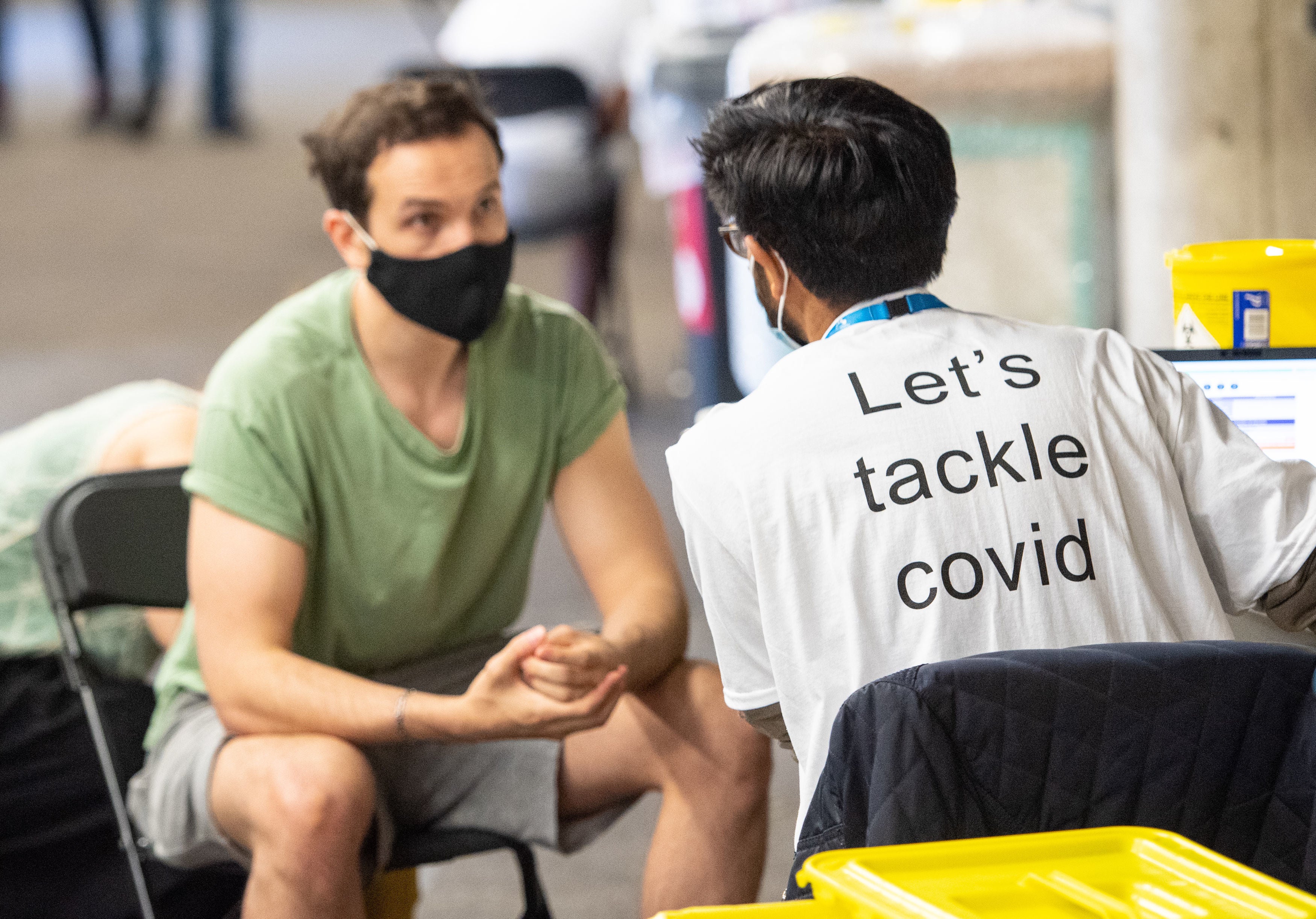 A man receives a coronavirus vaccination at Twickenham rugby stadium