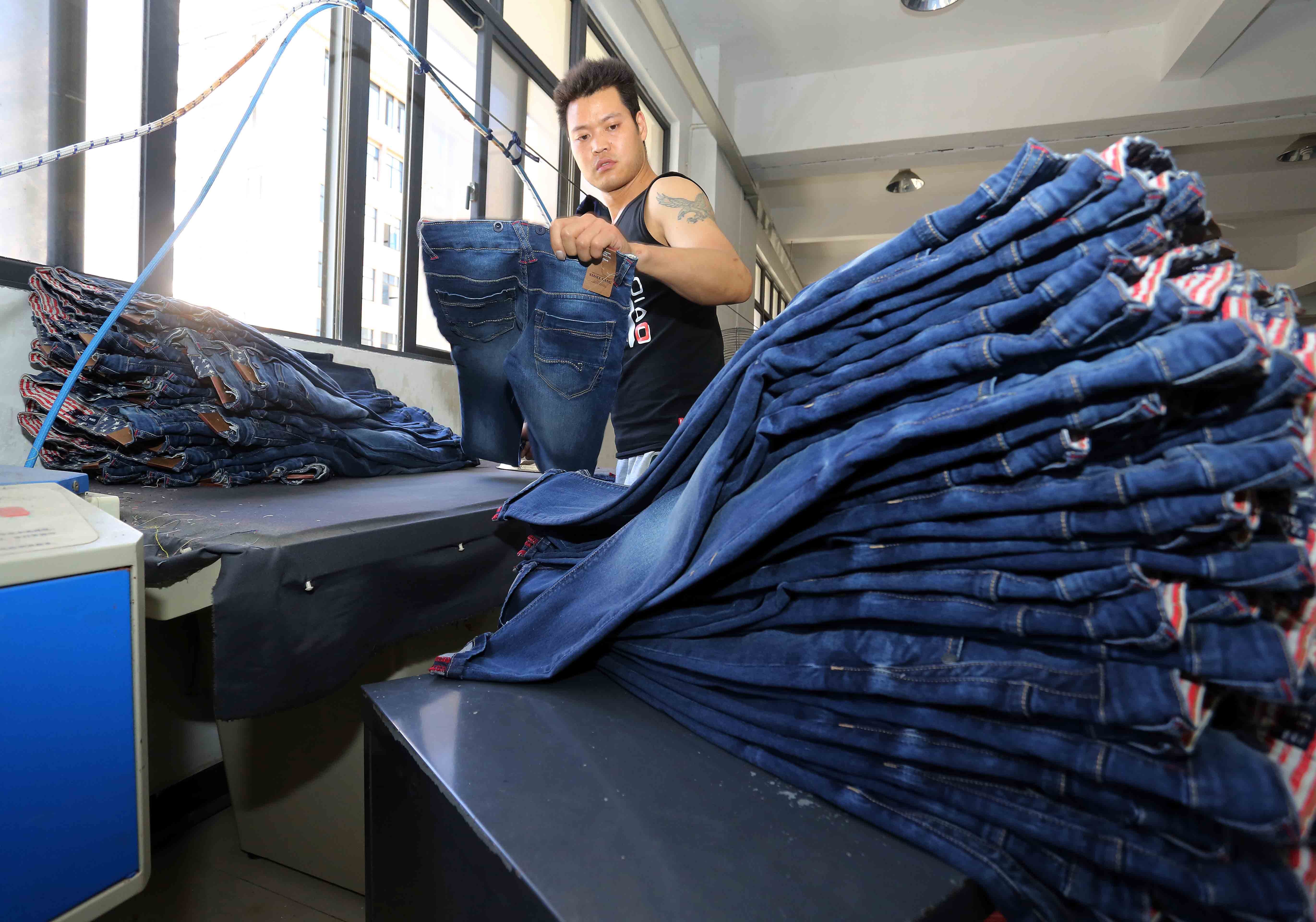 A worker makes jeans at a clothing factory in Shishi in eastern China’s Fujian Province