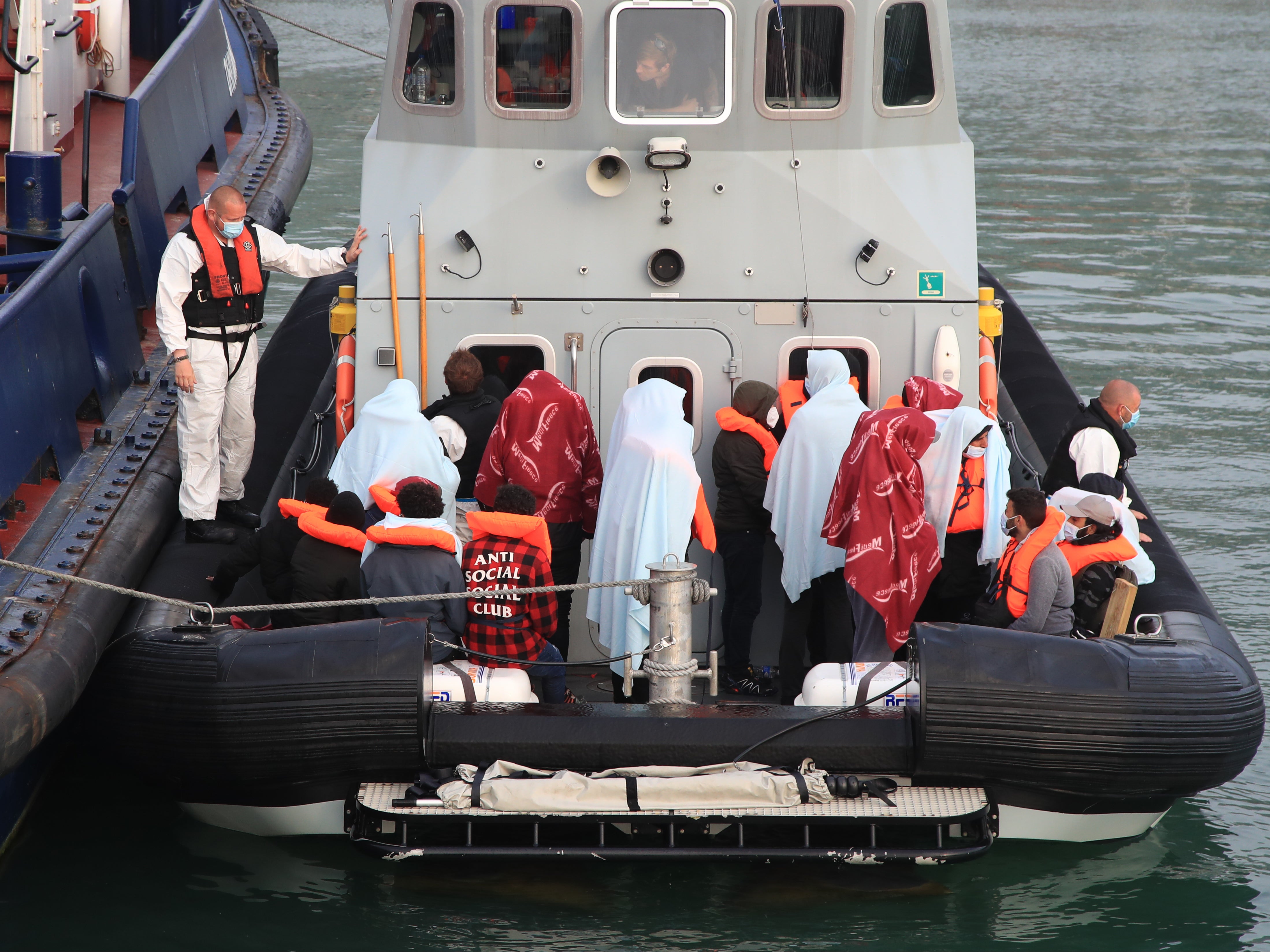 Migrants brought into Dover by Border Force officials on 3 June