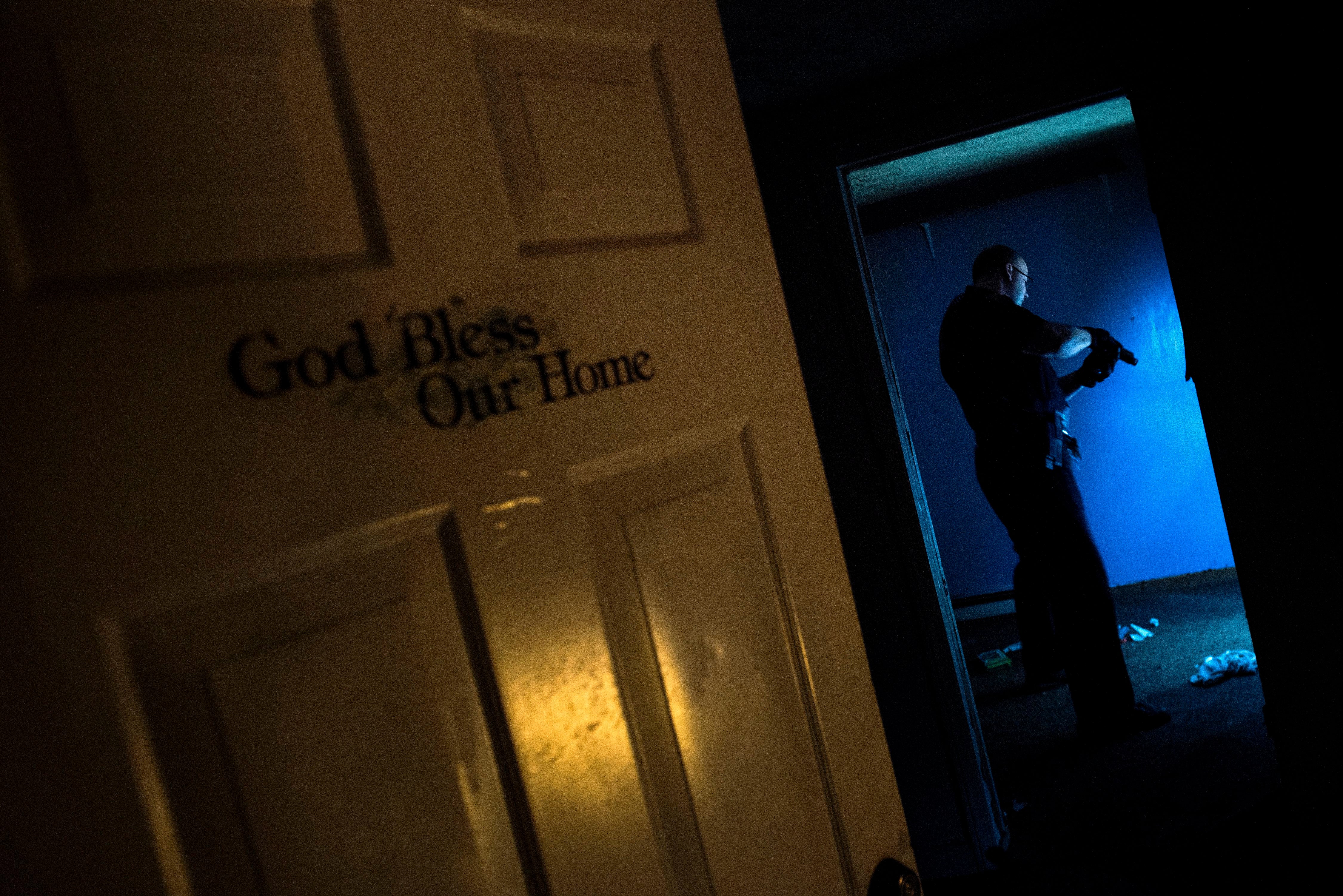 Huntington Police searches an abandoned house littered with needles in Huntington, West Virginia