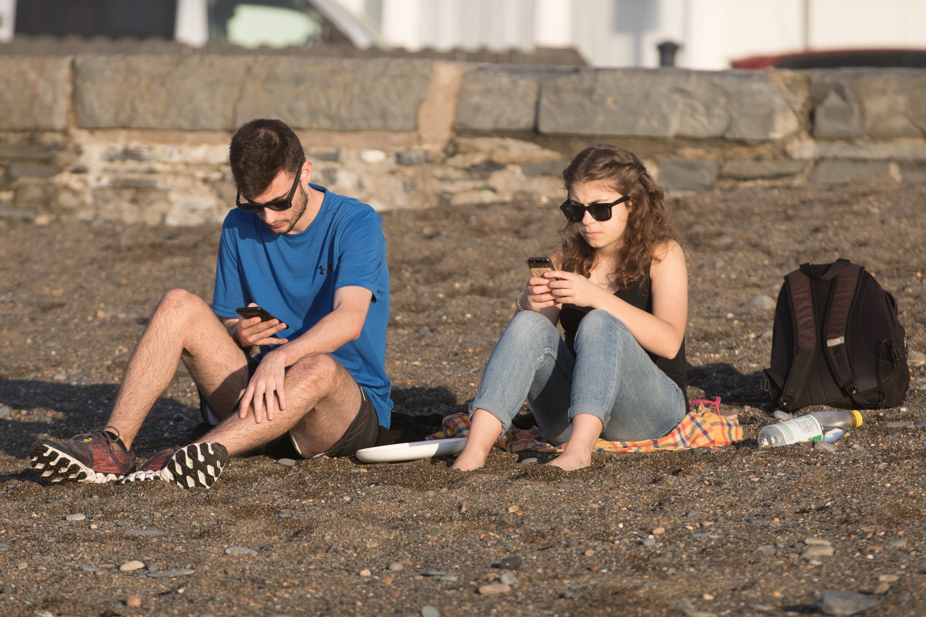 People using phone on the beach