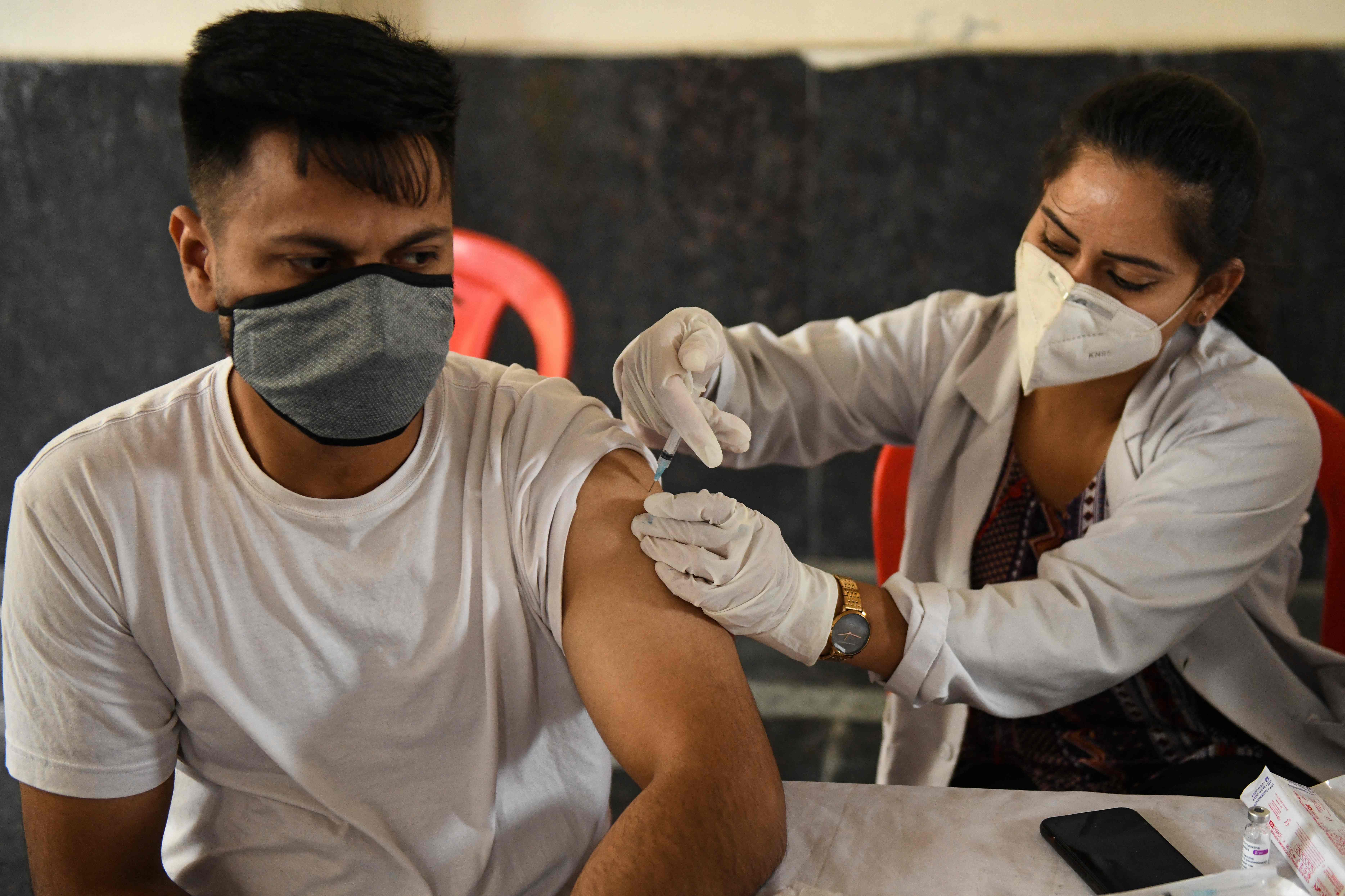 A medical worker inoculates a man with a dose of a Covid-19 vaccine at a health centre in Amritsar, India, on 20 May, 2021.