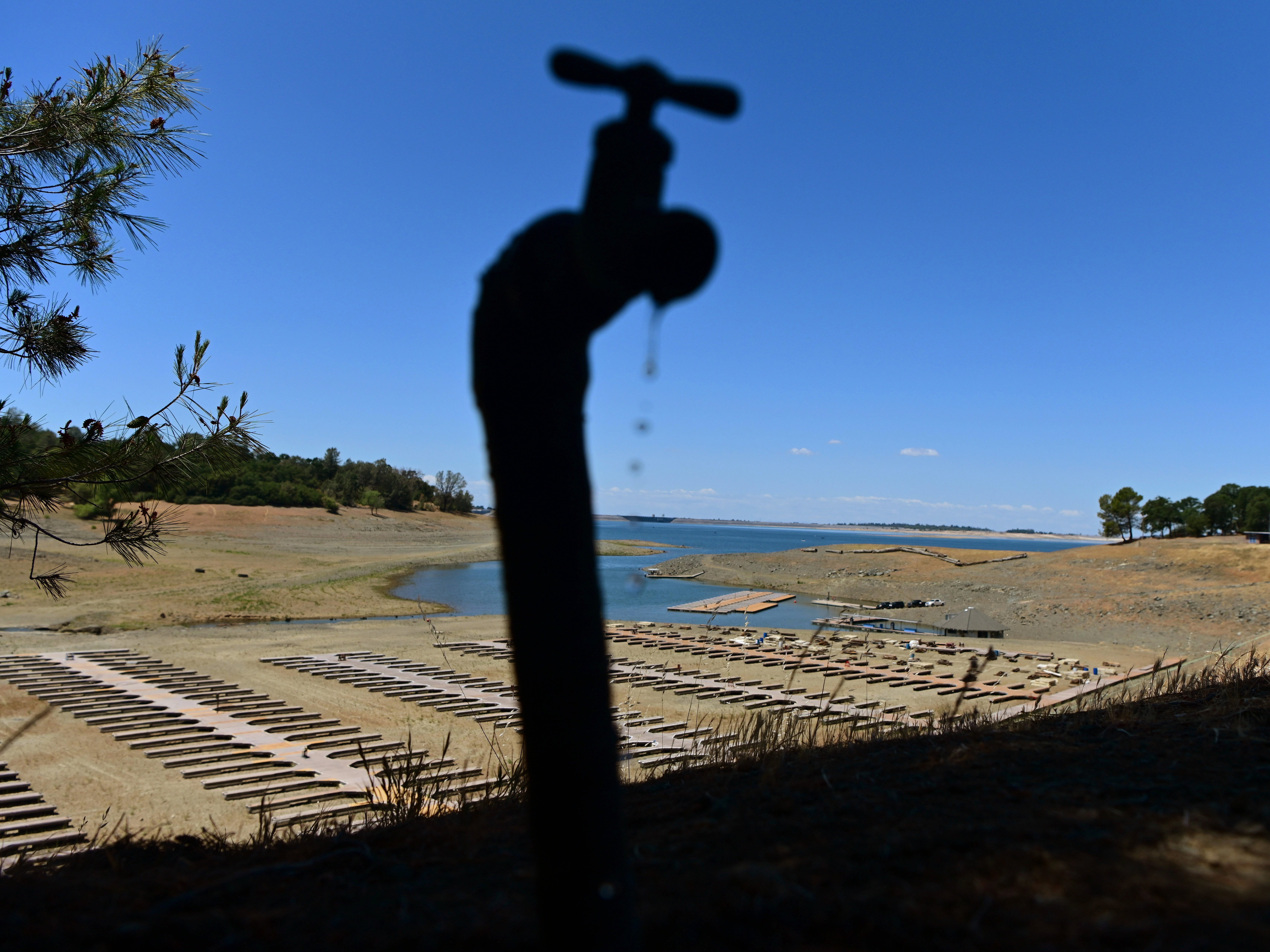 Water drips from a faucet near boat docks sitting on dry land at the Browns Ravine Cove area of drought-stricken Folsom Lake, currently at 37 per cent of its normal capacity, in Folsom, California Saturday, 22 May 2021