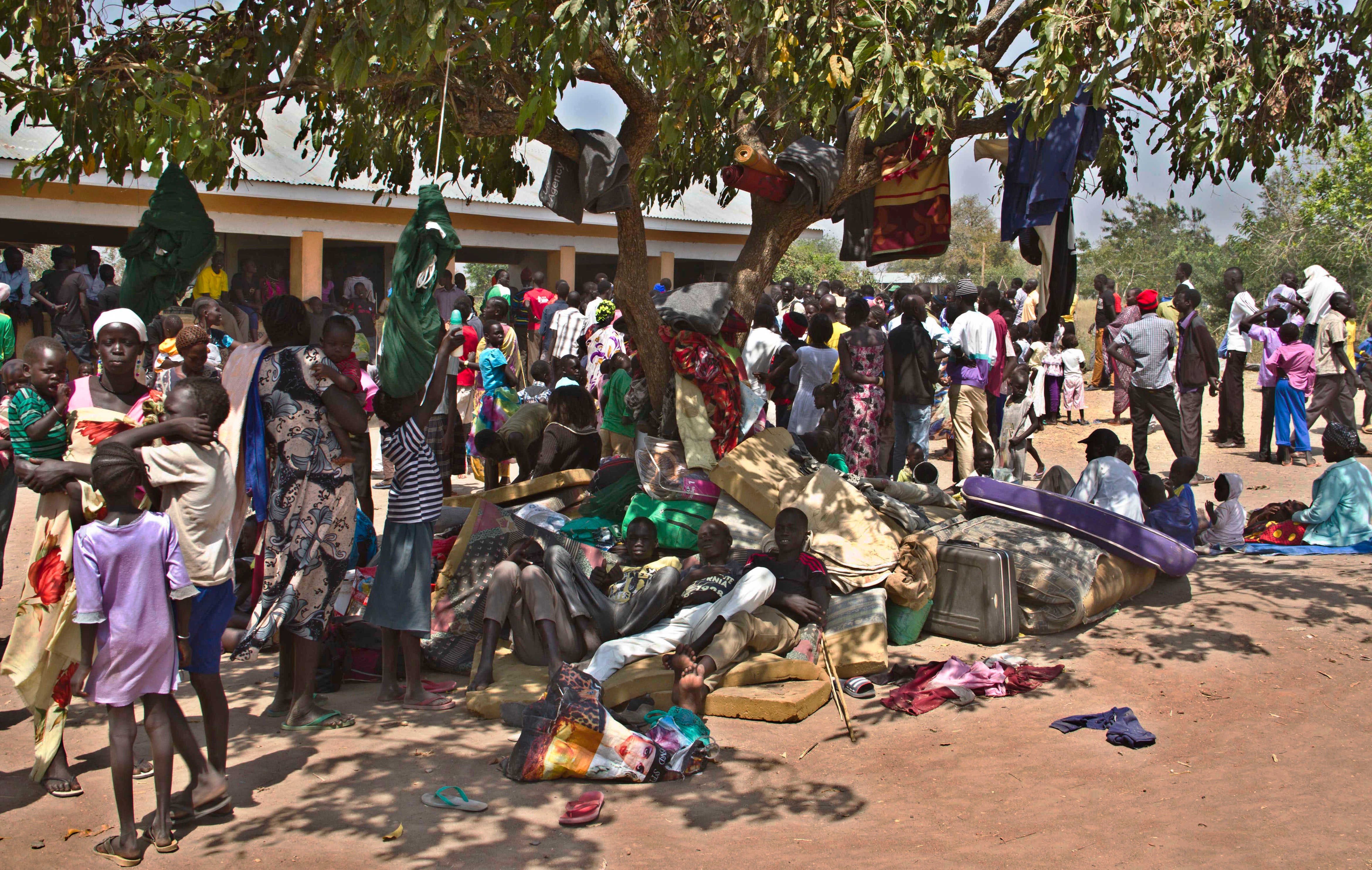 South Sudanese families accepted as refugees in Uganda shelter in the shade of a tree at the Ochaya Rhino refugee camp in Arua District