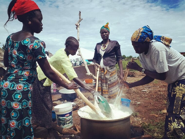 A group of women cooking ahead of the youth conference in the Bidibidi camp