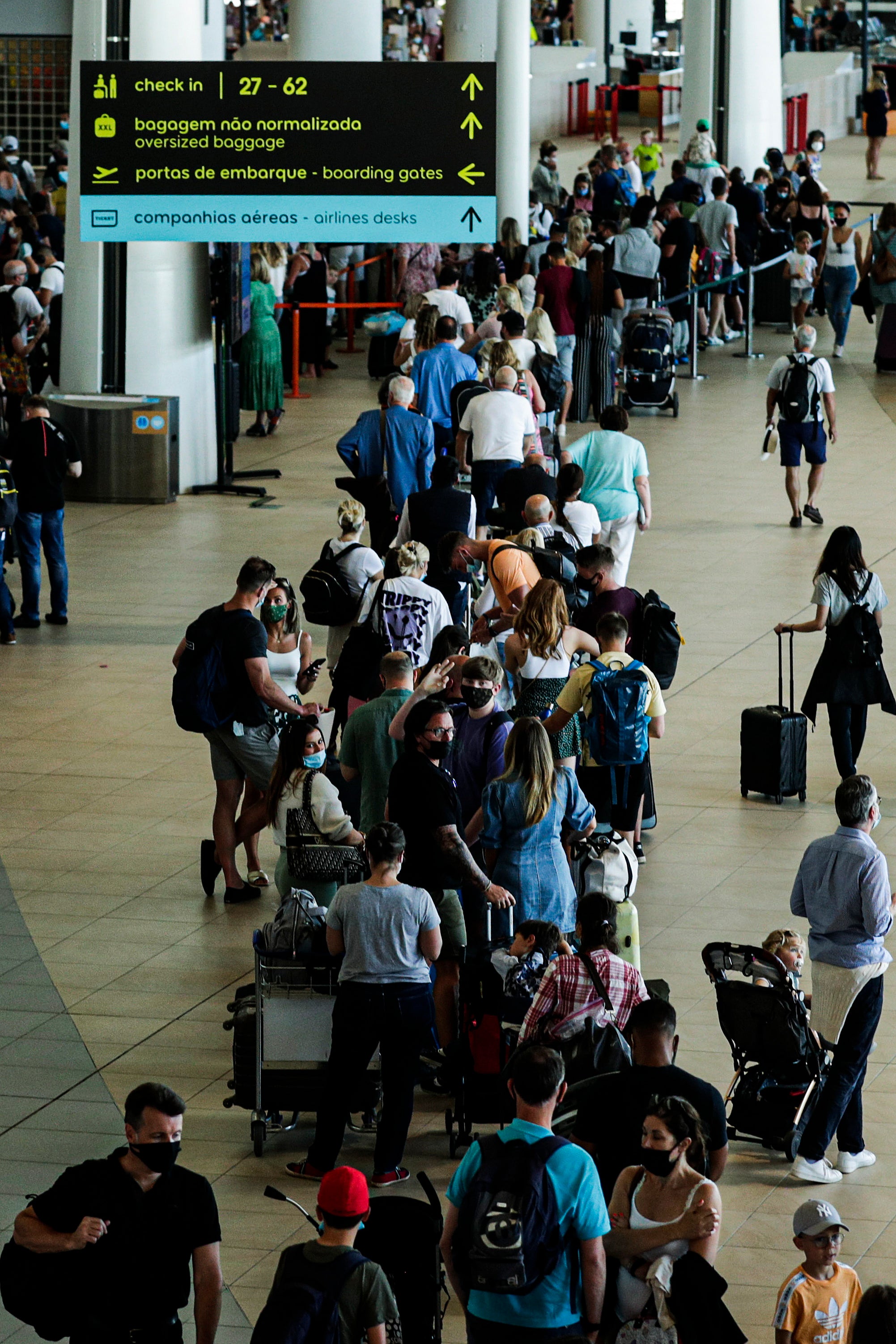 British tourists queue to check-in at Faro airport in Portugal