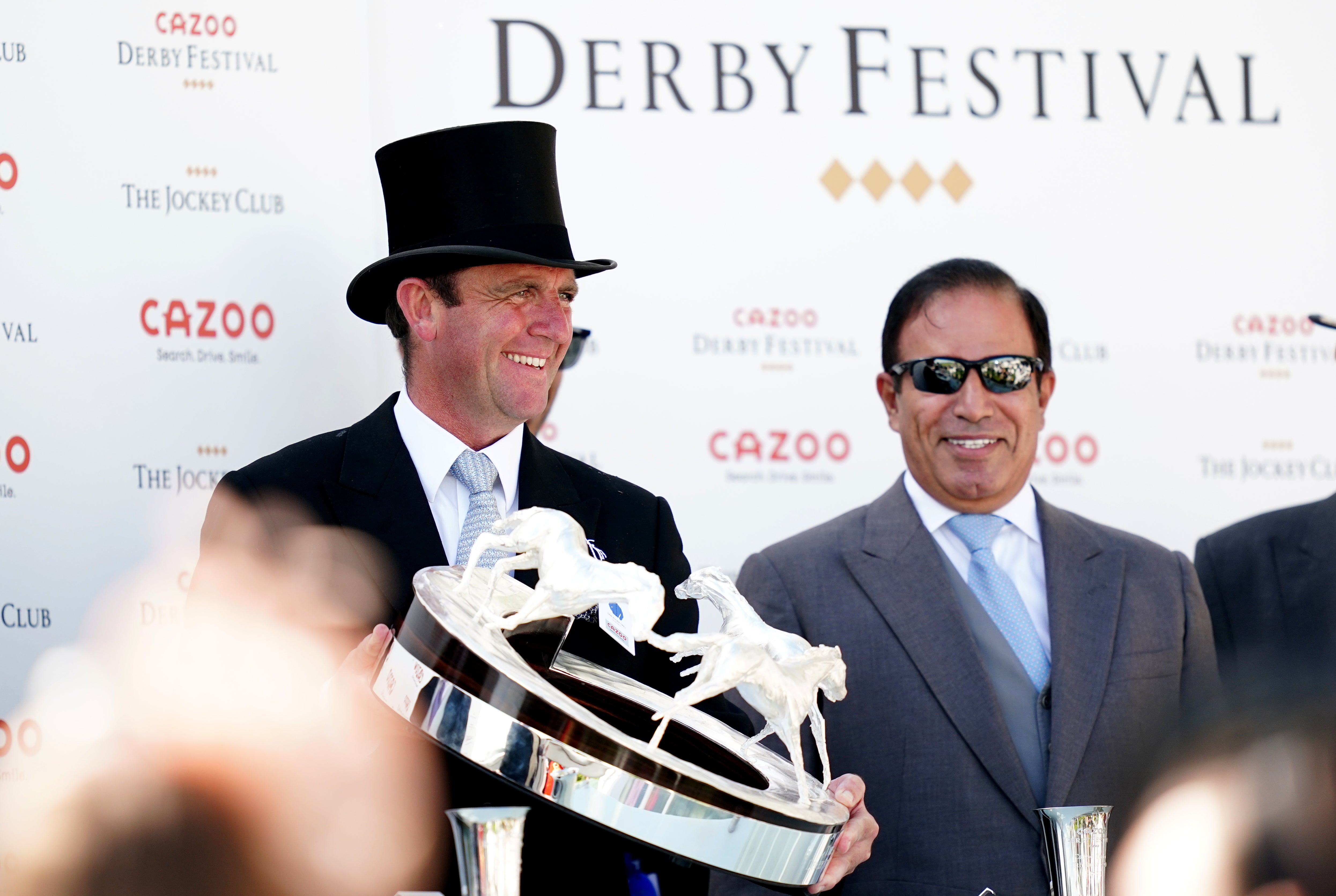 Trainer Charlie Appleby celebrates with the trophy at Epsom