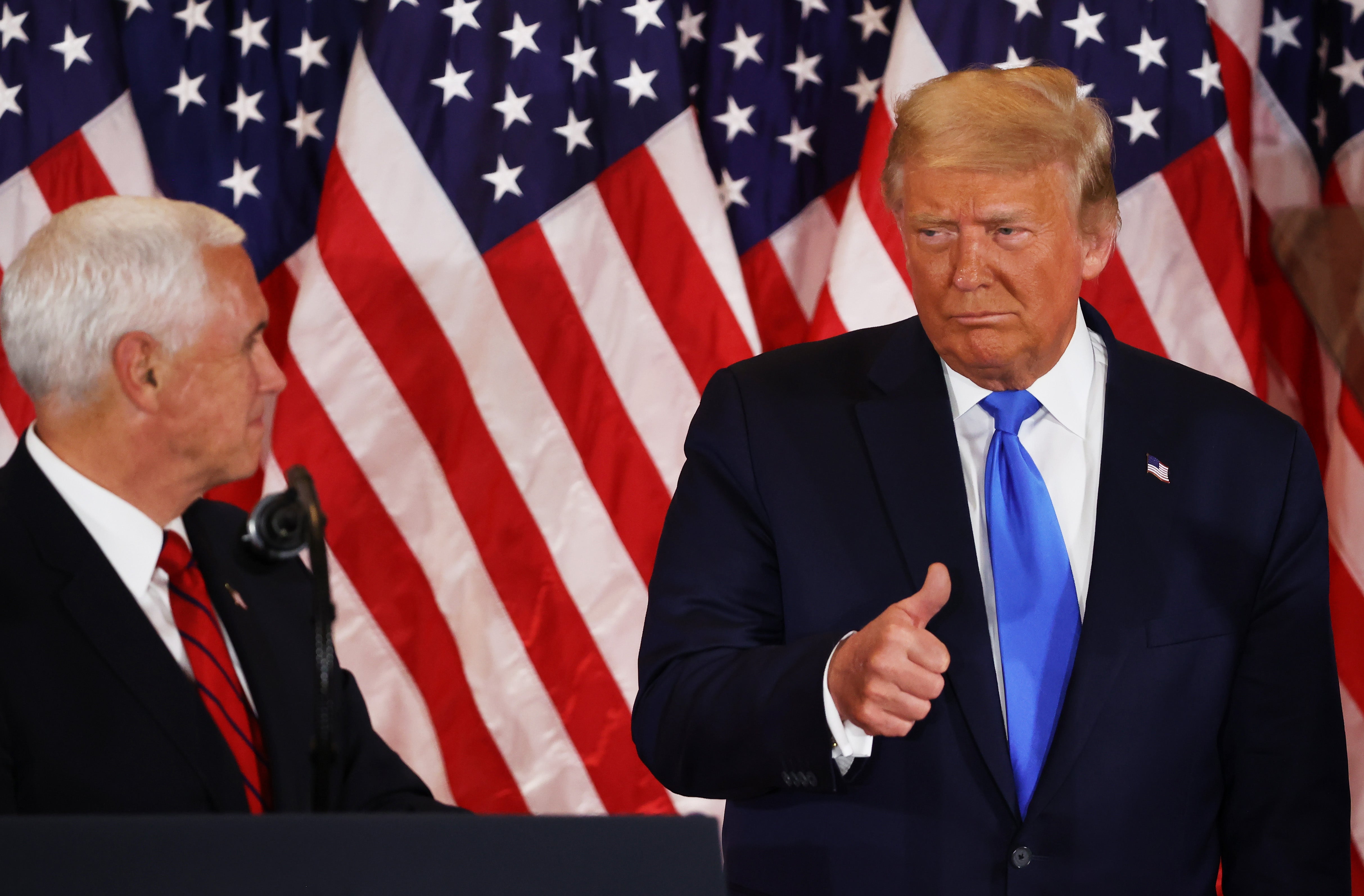 US President Donald Trump gestures to Vice President Mike Pence on election night in the East Room of the White House in the early morning hours of November 04, 2020 in Washington, DC