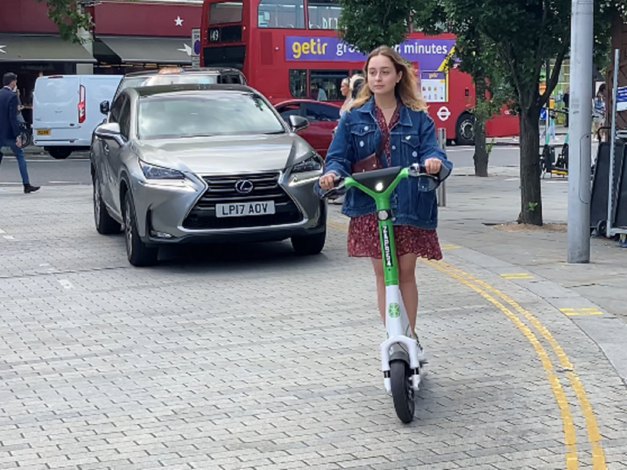 Beata Onikul, 20, hires a rental e-scooter in South Kensington, London, on the first day of a 12-month government-backed trial