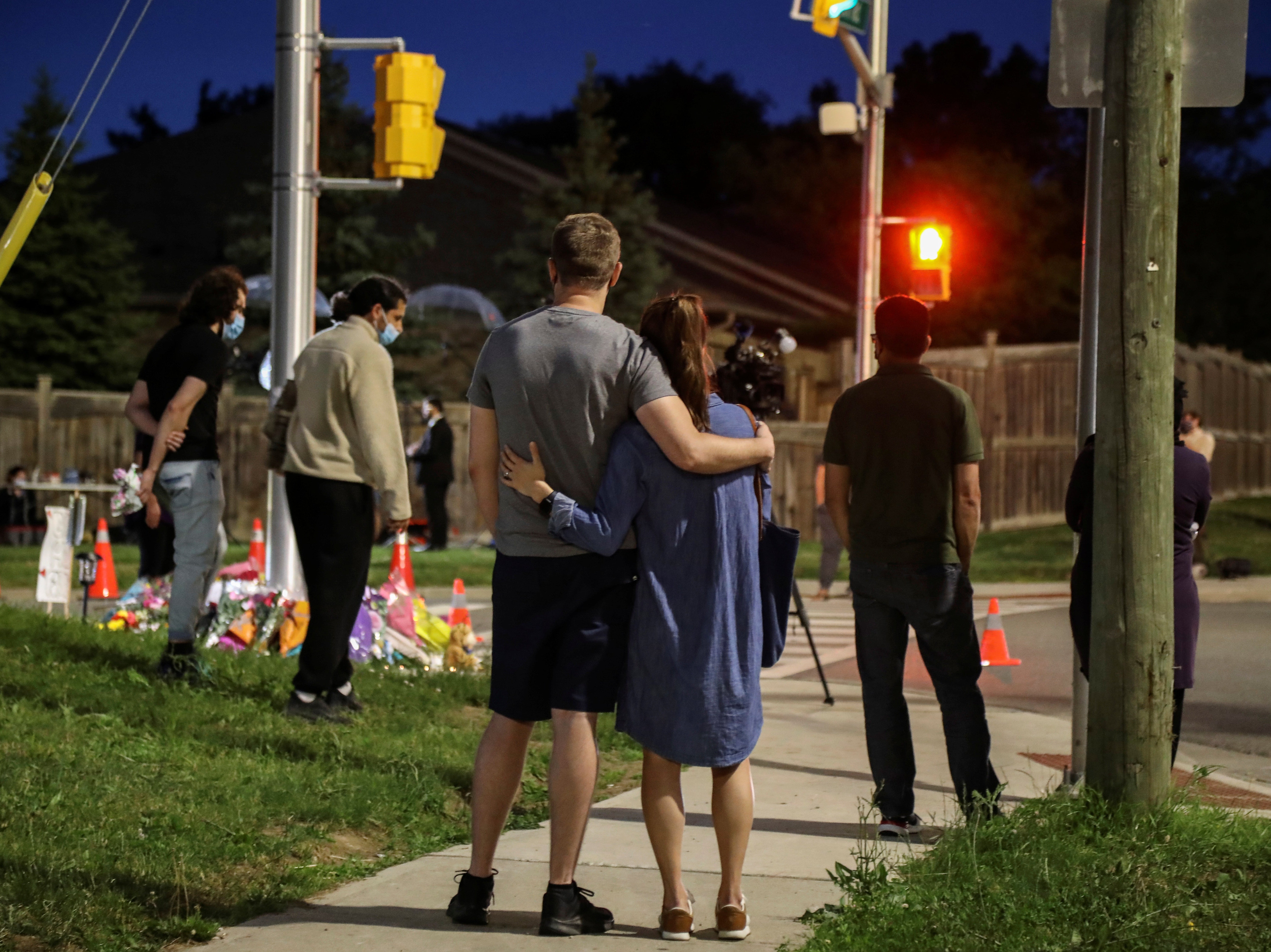 People gather at a makeshift memorial after four members of a Muslim family were struck by a truck and killed in London, Ontario