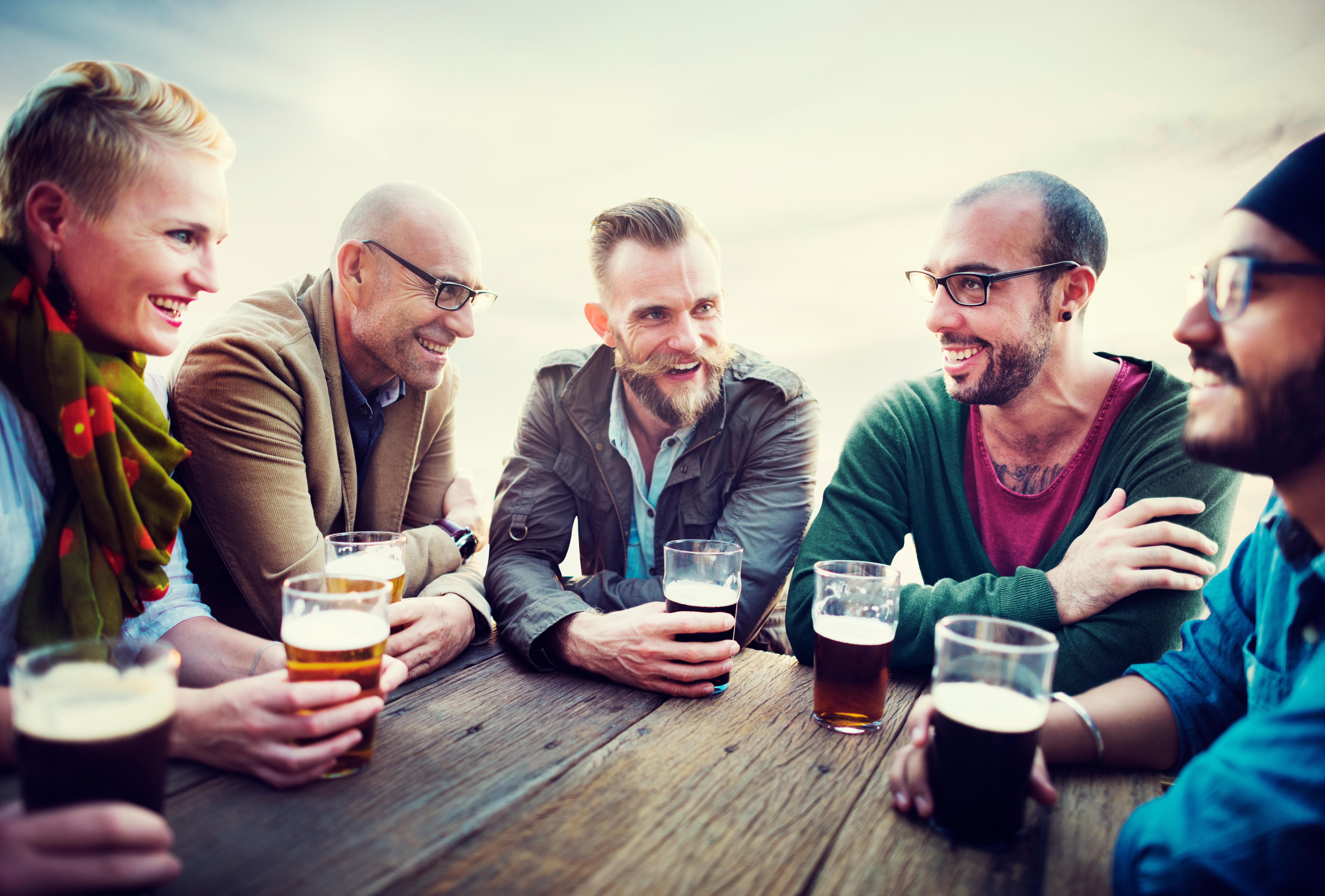 group of men and women having drinks at a pub