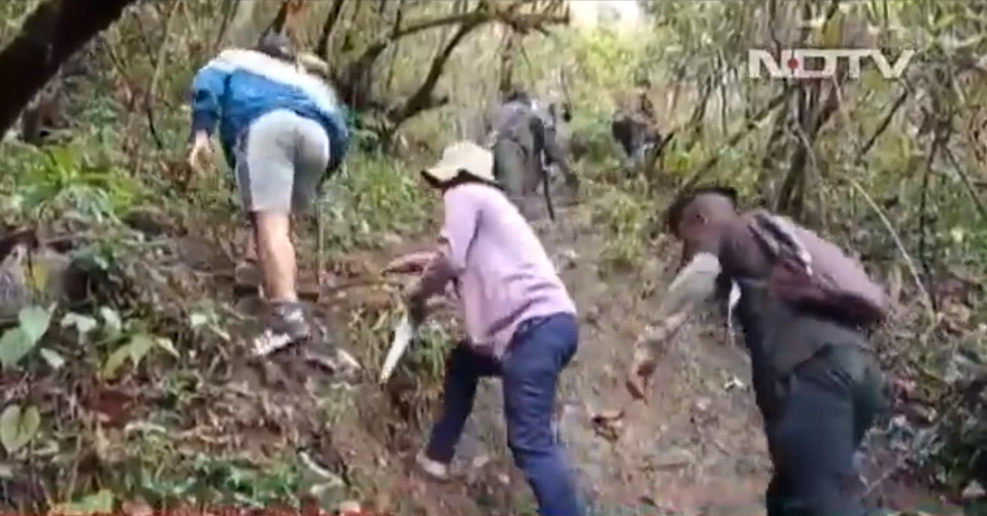 Students in a remote village in Mizoram trekking up the hill in search of internet to take their online semester exams