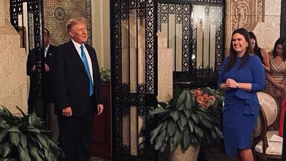 Sarah Huckabee Sanders and Donald Trump at a campaign event at Mar-a-Lago