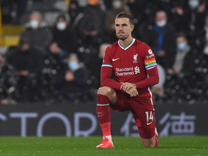 Jordan Henderson takes the knee