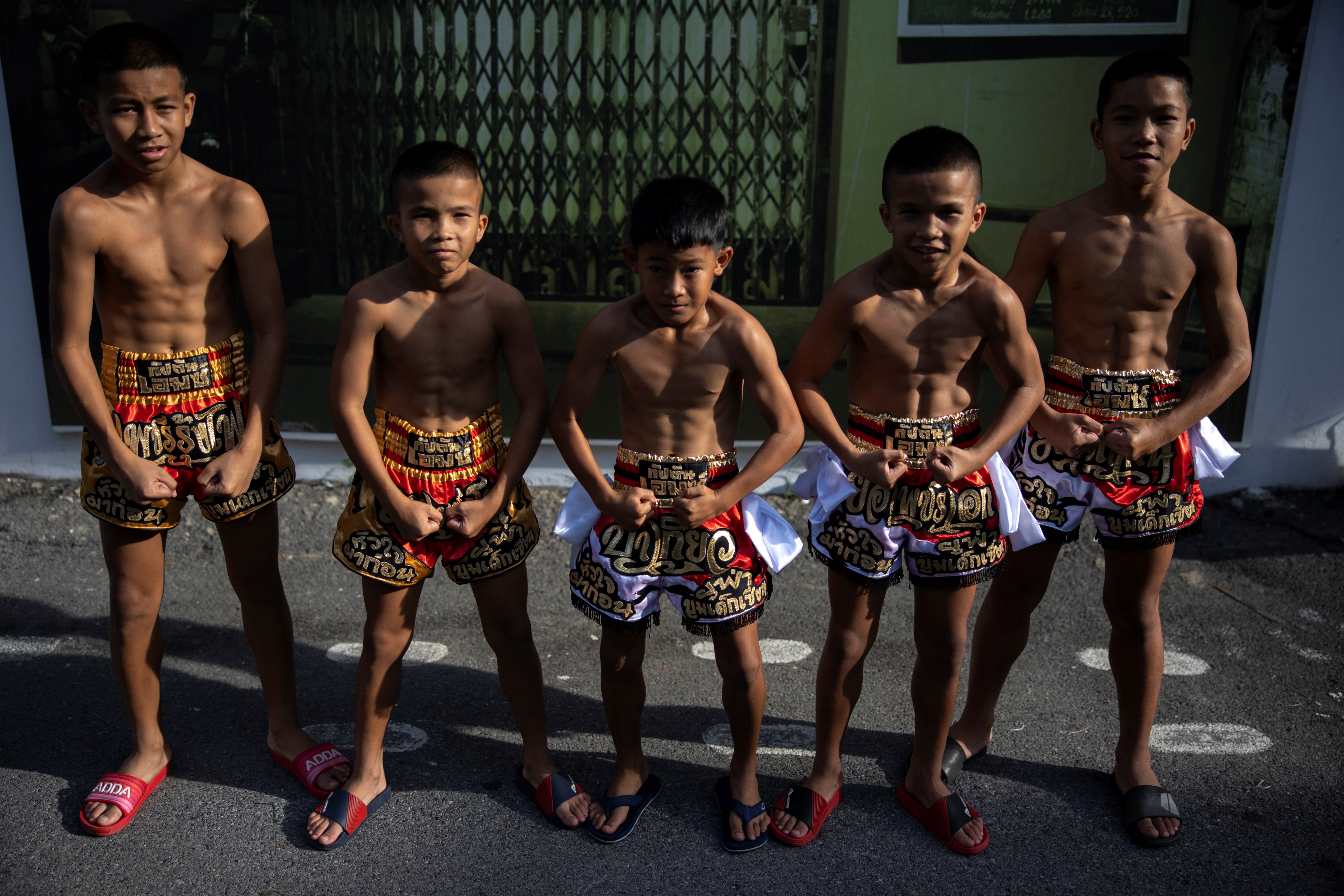 Muay thai boxers pose for a photograph at the Rangsit Boxing stadium