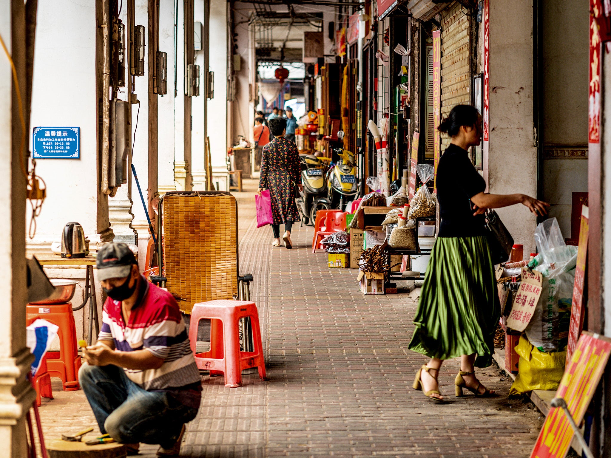 Scenes from everyday life under a pedestrian arcade street of Qilou old town