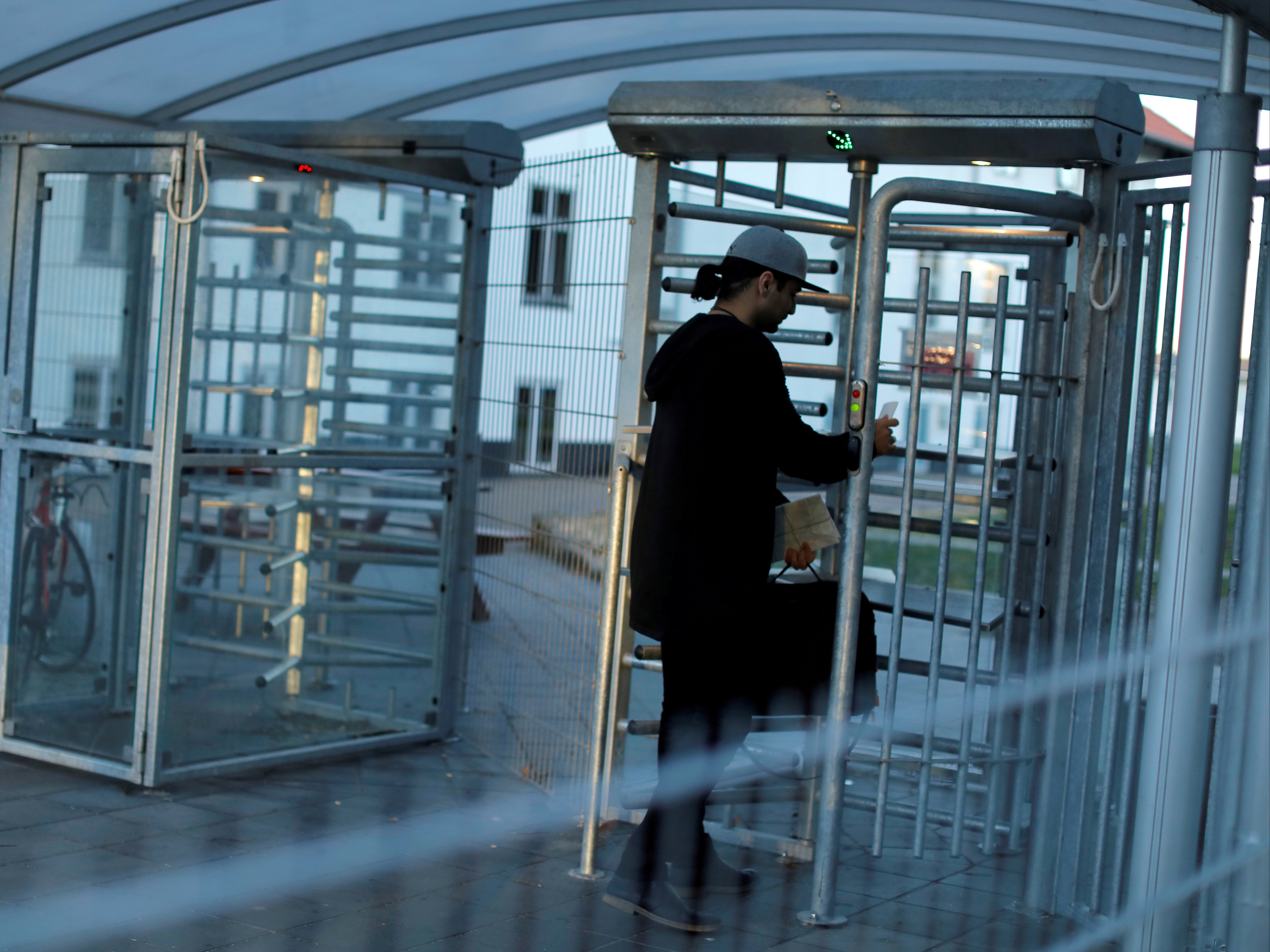 A Kurdish Iraqi man enters through the front gate of Kaershovedgaard, a former prison now a departure centre for rejected asylum seekers in Jutland, Denmark