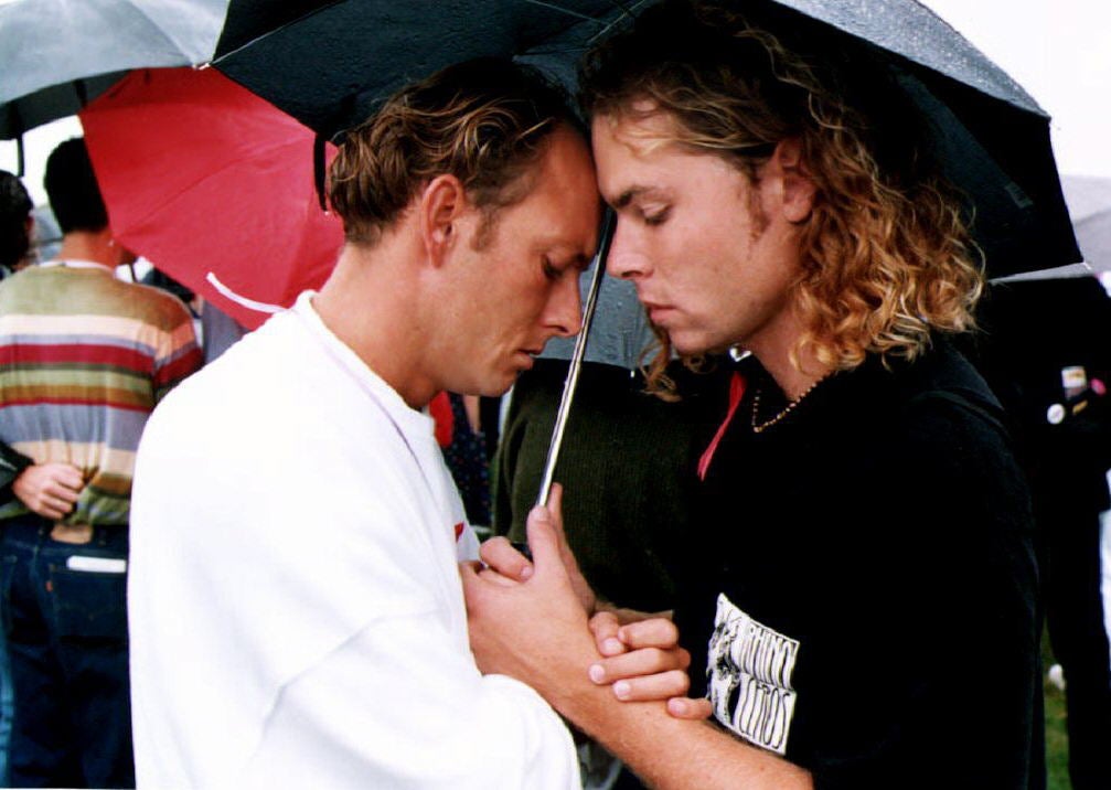 Craig Cobine and Wesley Allen comfort each other during a roll call of people who have died from Aids in Washington DC in 1992