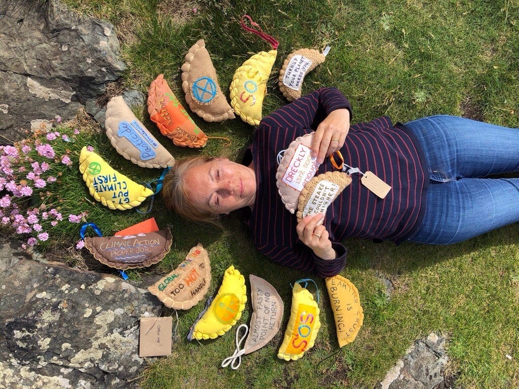 Extinction Rebellion supporter Sarah White surrounded by knitted pasties