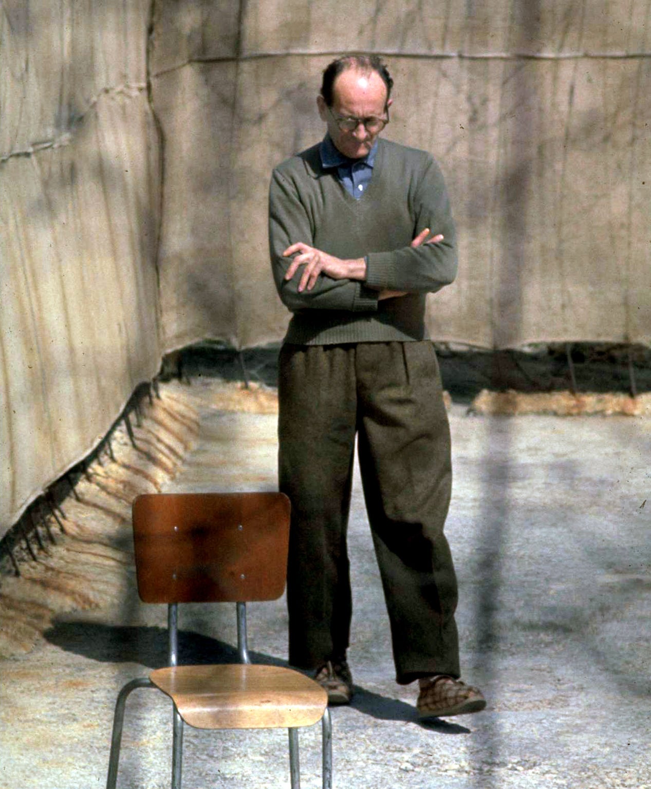 Eichmann (1906-1962) paces in the yard at Ramle Prison, central Israel, on 1 April 1961, 10 days before the start of his trial