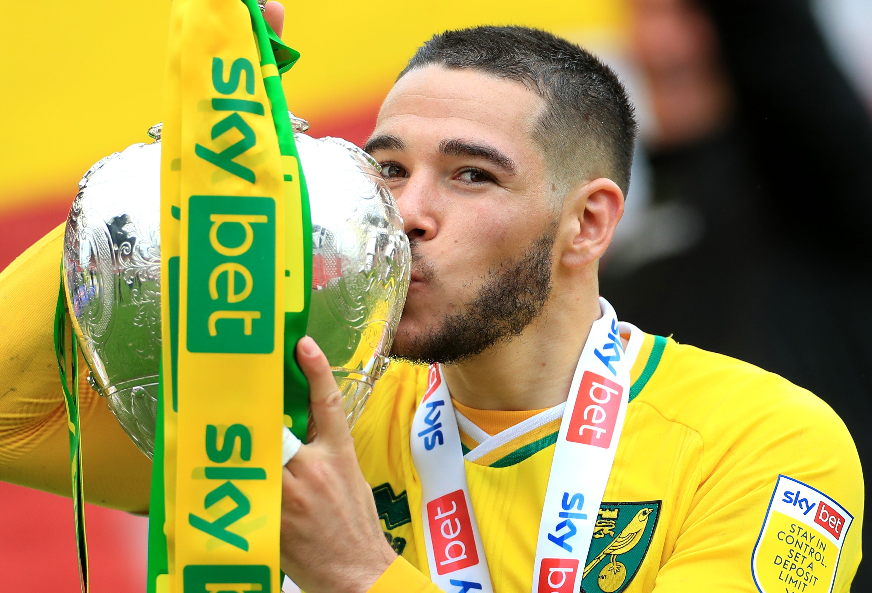 Emi Buendia celebrates with the Sky Bet Championship trophy