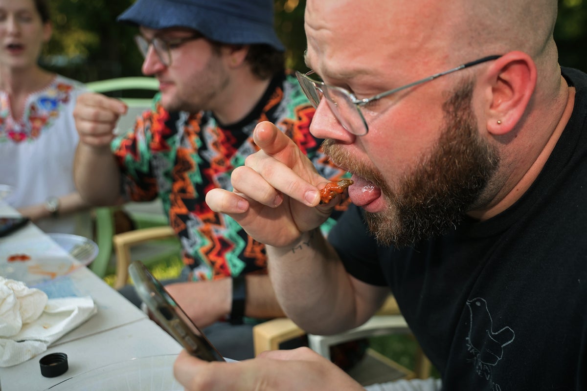 Contestants eat cicadas during a Hot One challenge in Maryland