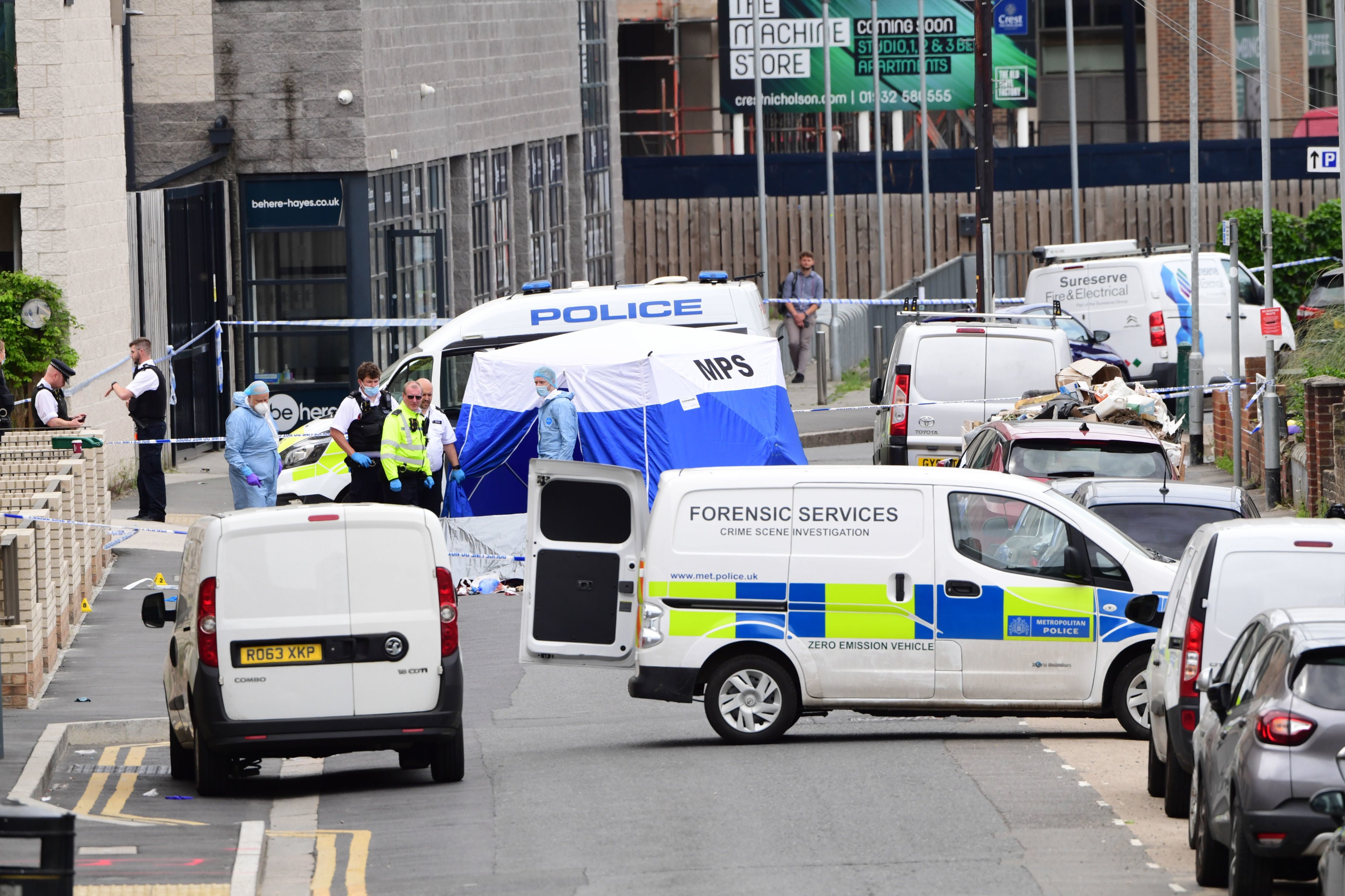 Forensic officers join police on the scene of the stabbing in Hayes