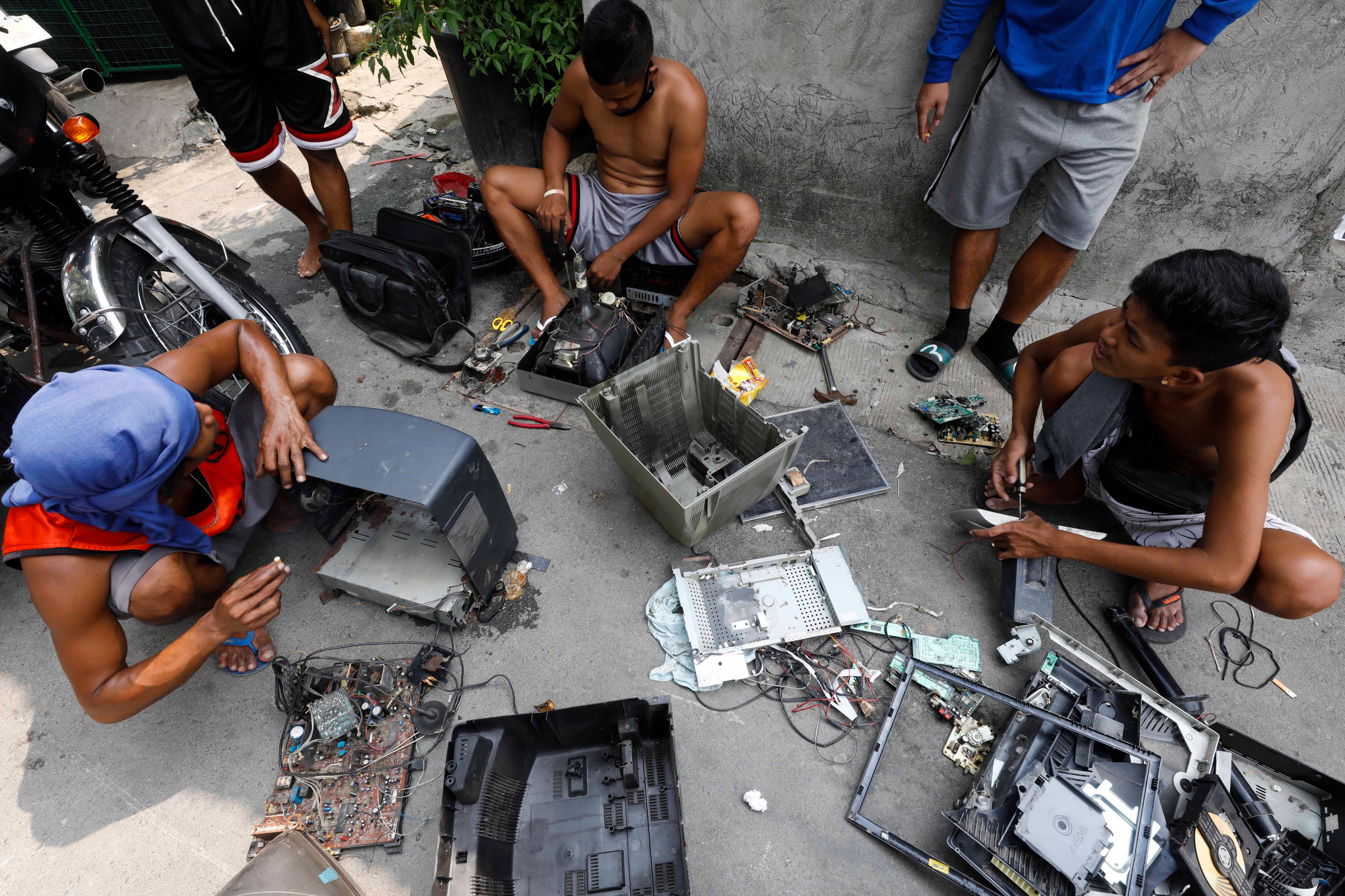 Discarded electronic products, including television sets, are dismantled for reusable parts in the Philippines