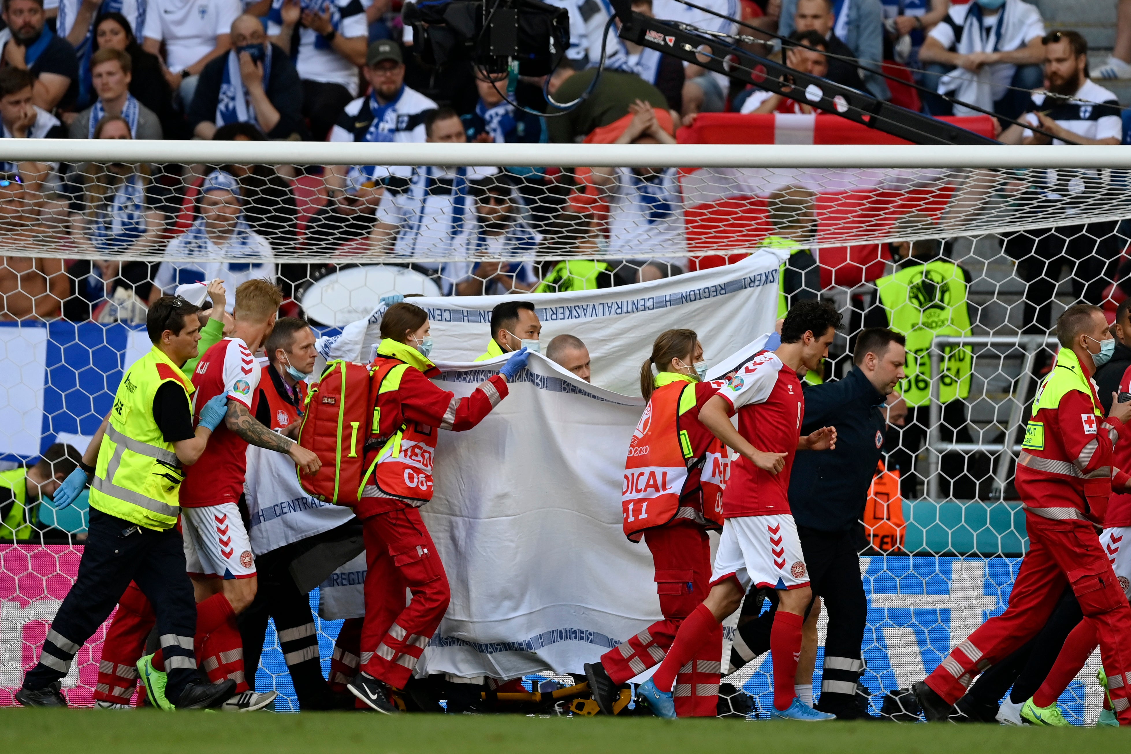 Denmark’s Christian Eriksen is taken away on a stretcher after collapsing on the pitch