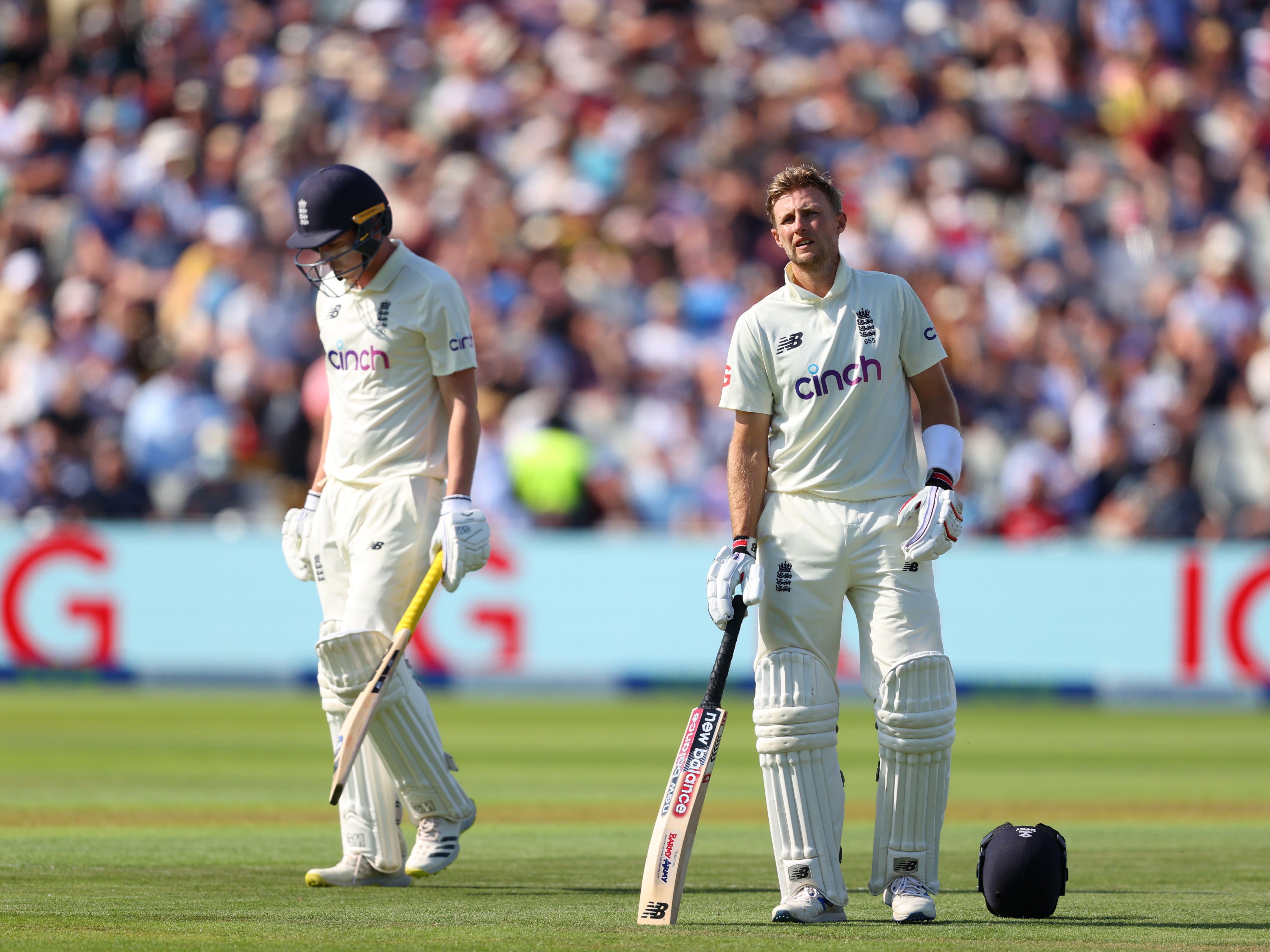 England batsman Dan Lawrence walks off after being dismissed for 0 as captain Joe Root looks on