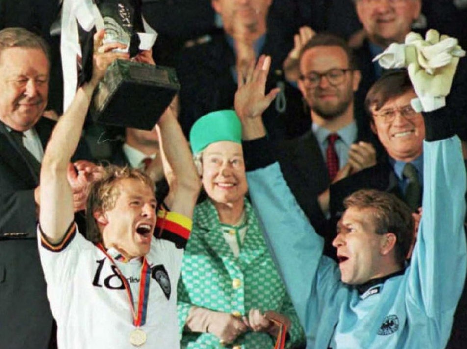 Klinsmann lifts the Euro 96 trophy as Queen Elizabeth II watches on at Wembley