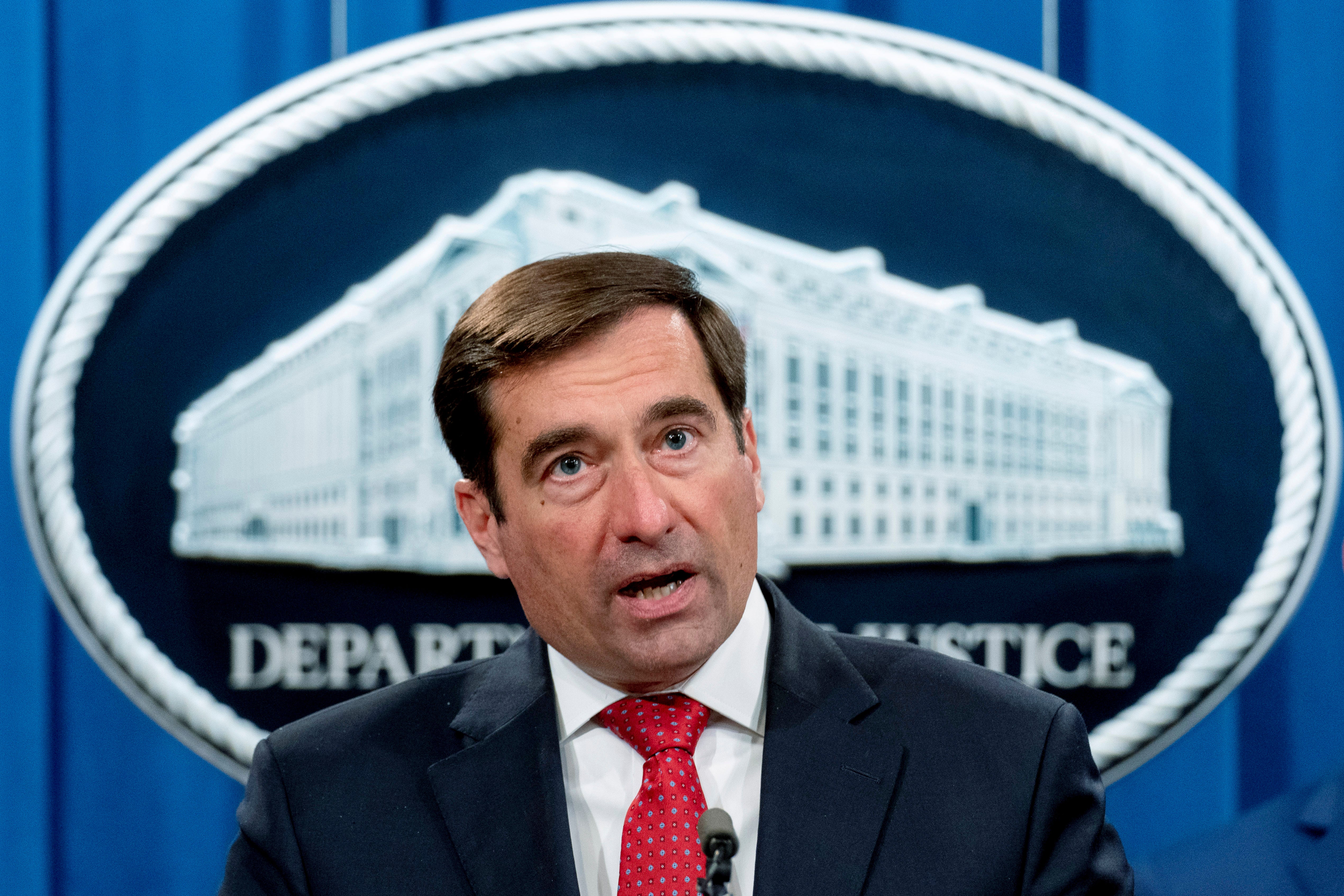 John Demers gives a press briefing at the Justice Department