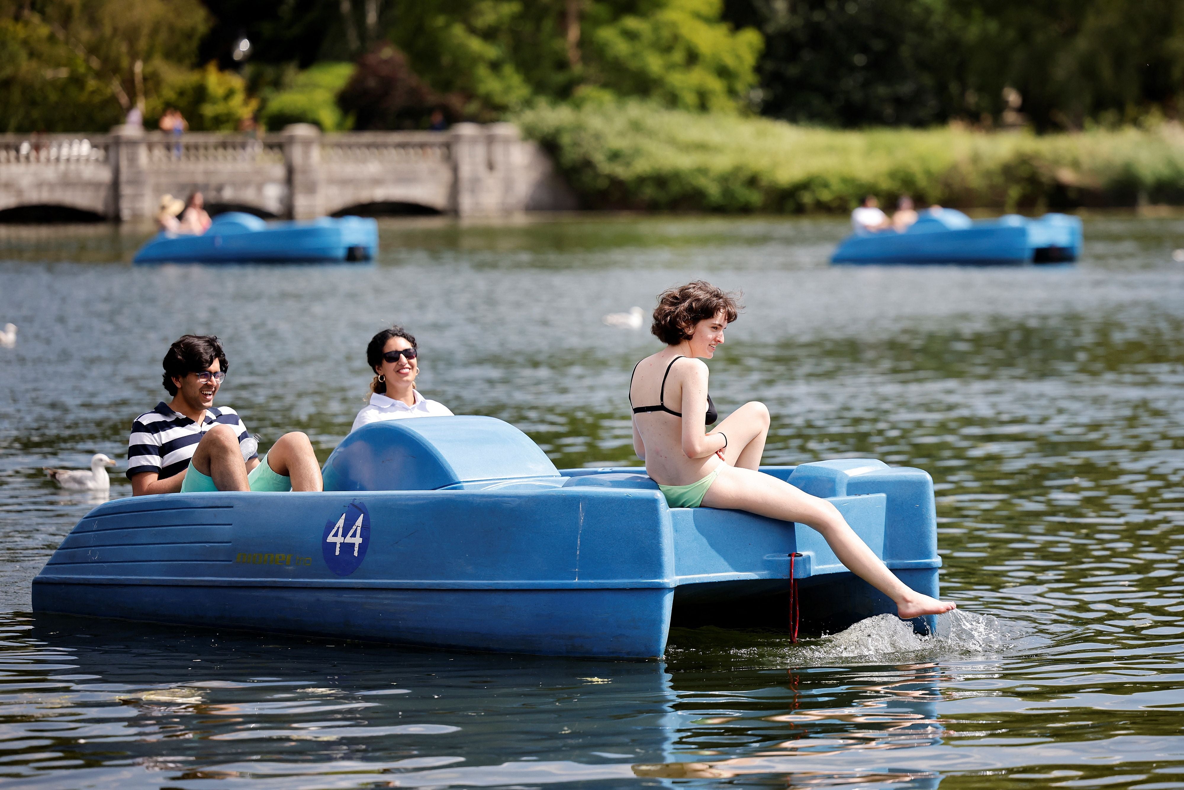 People ride in a pedalo in the sunshine in Hyde Park in London