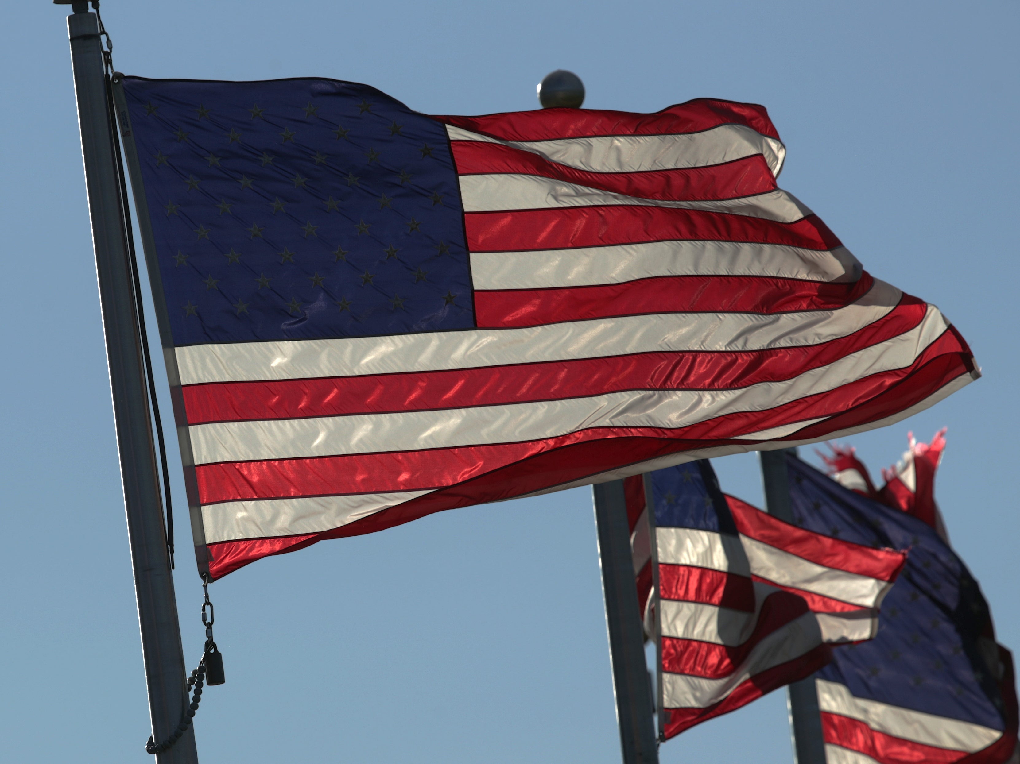 US flags fly on the ground of the Washington Monument on Flag Day 14 June 2019 in Washington, DC