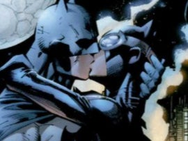 Batman and Catwoman share a kiss in the comics