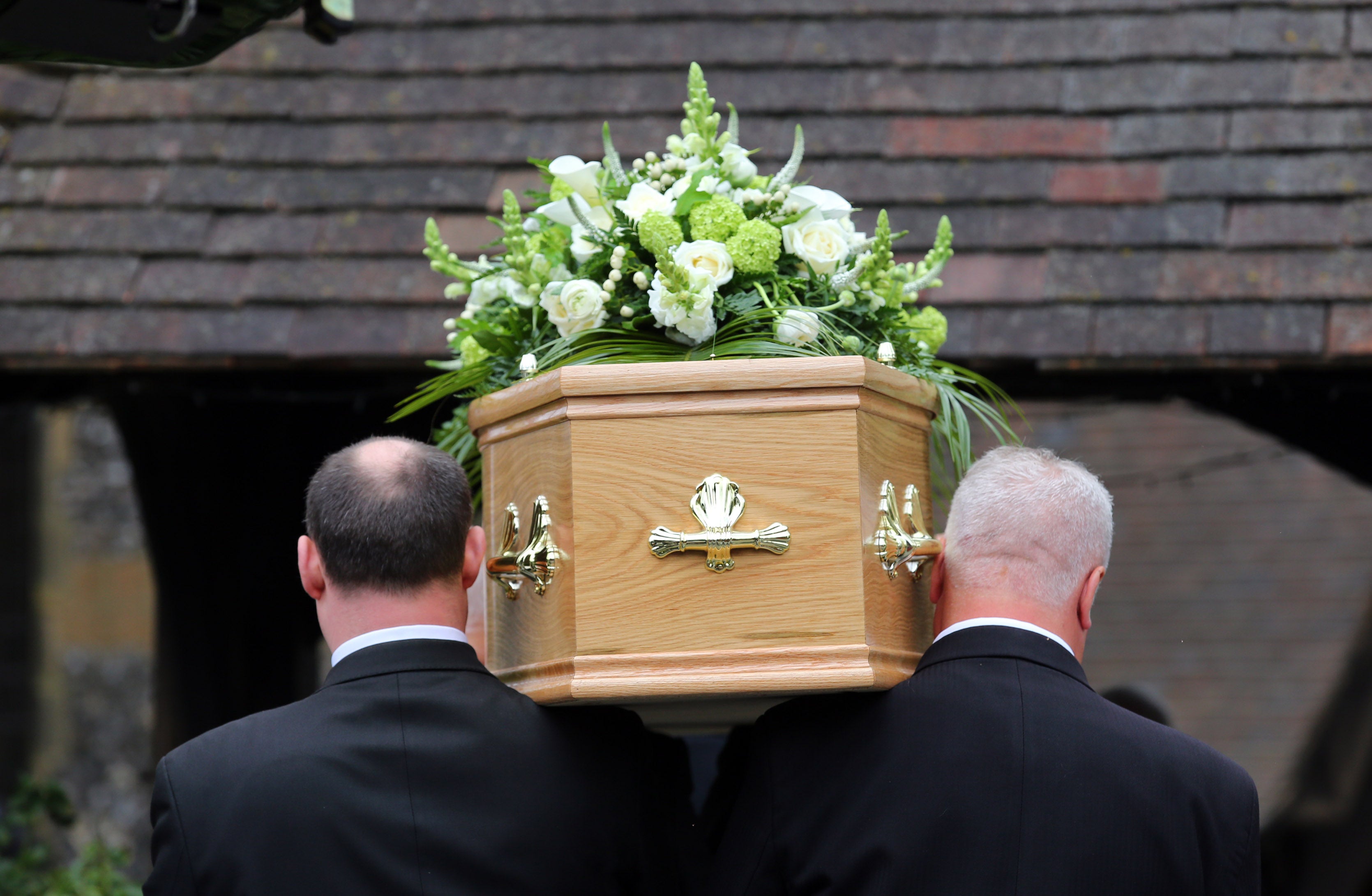 Pallbearers carrying a coffin at a funeral