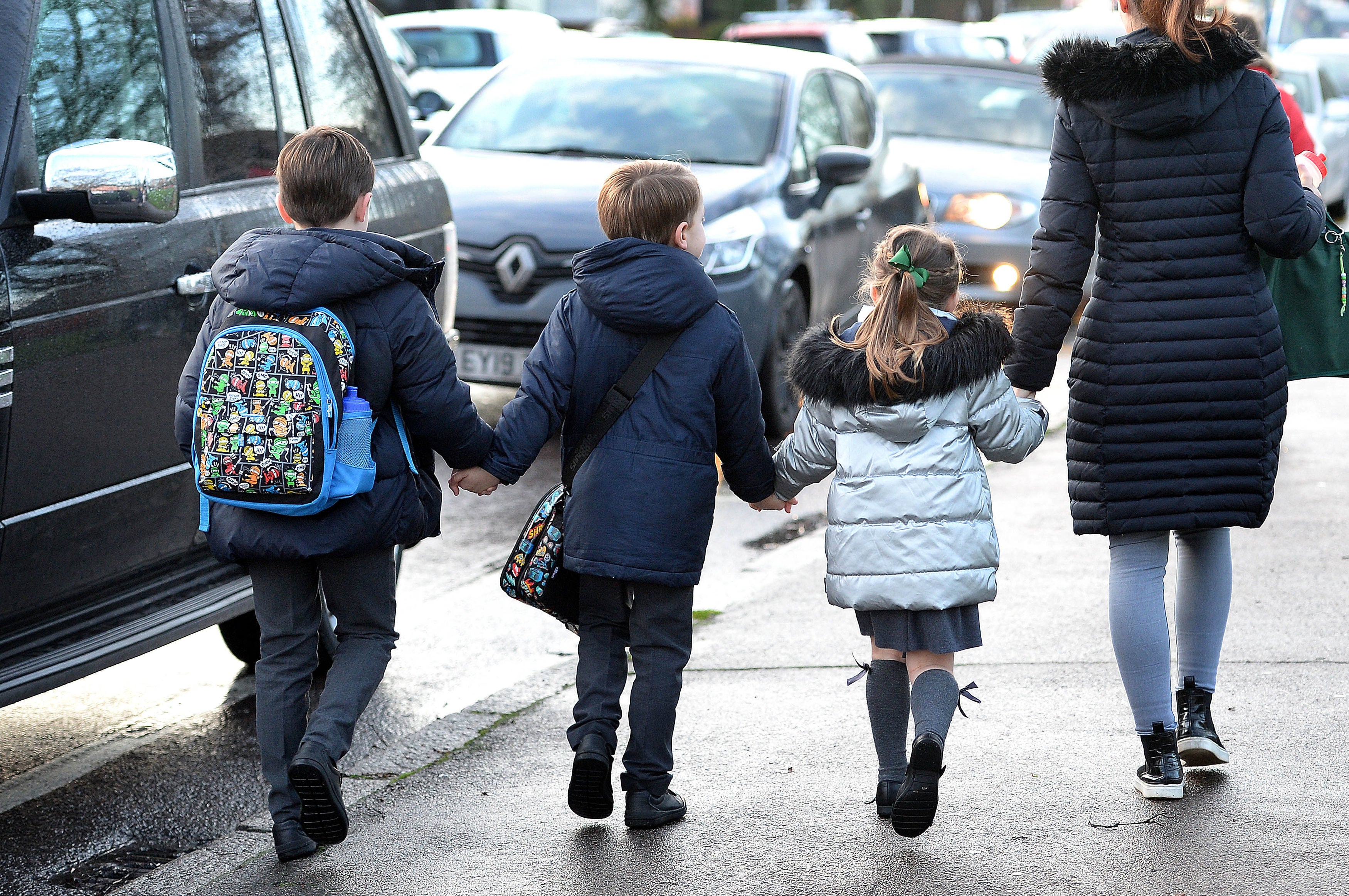 Air pollution: children walking to school past idling vehicles